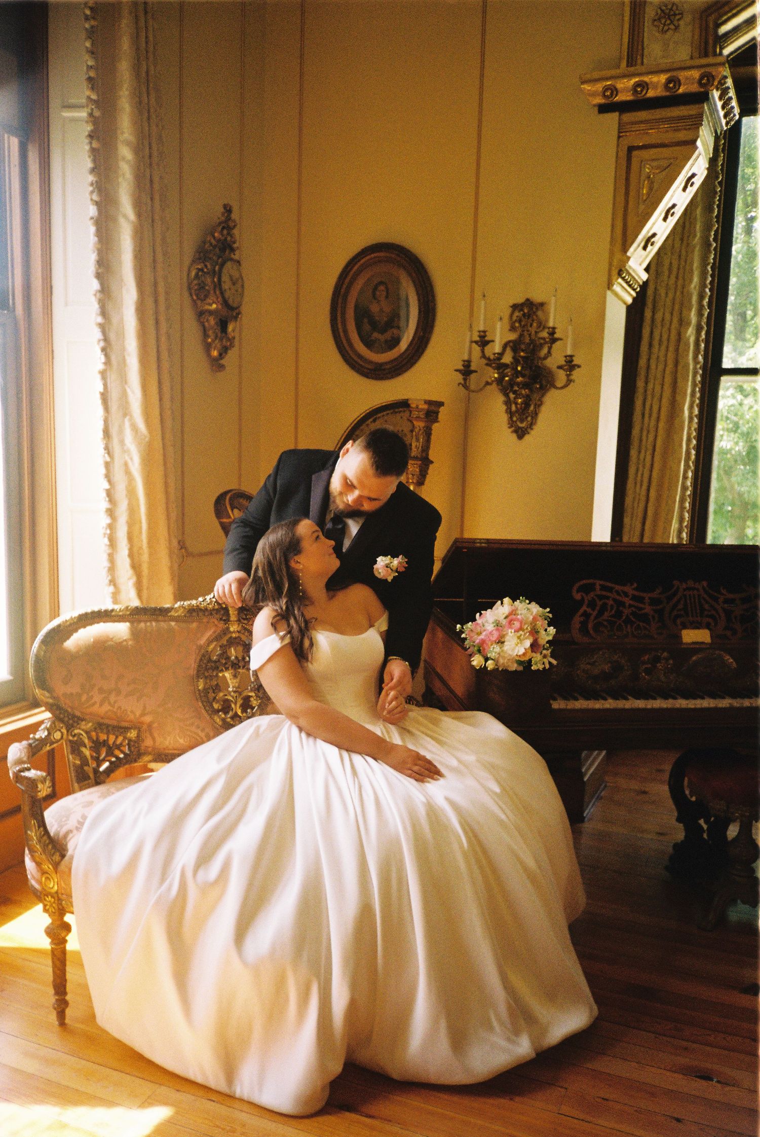 A series of romantic wedding photos showing a couple in formal attire posing on elegant furniture in a vintage room.