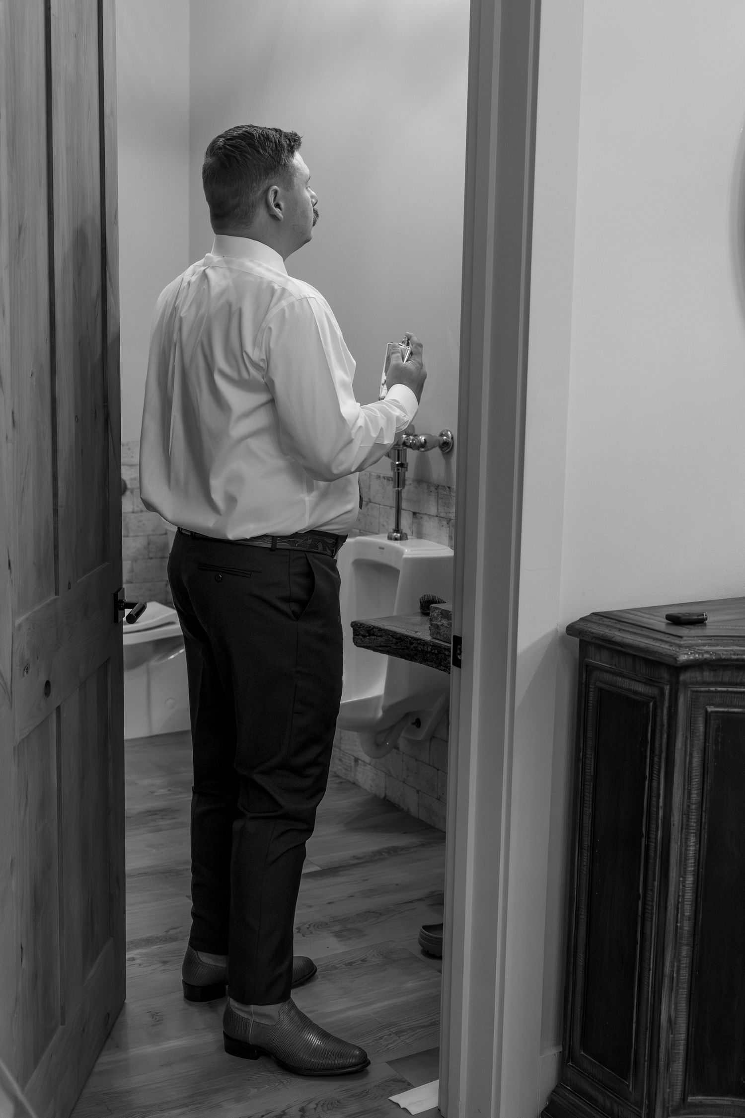 Black and white photos showing someone checking door handles in a hallway sequence.
