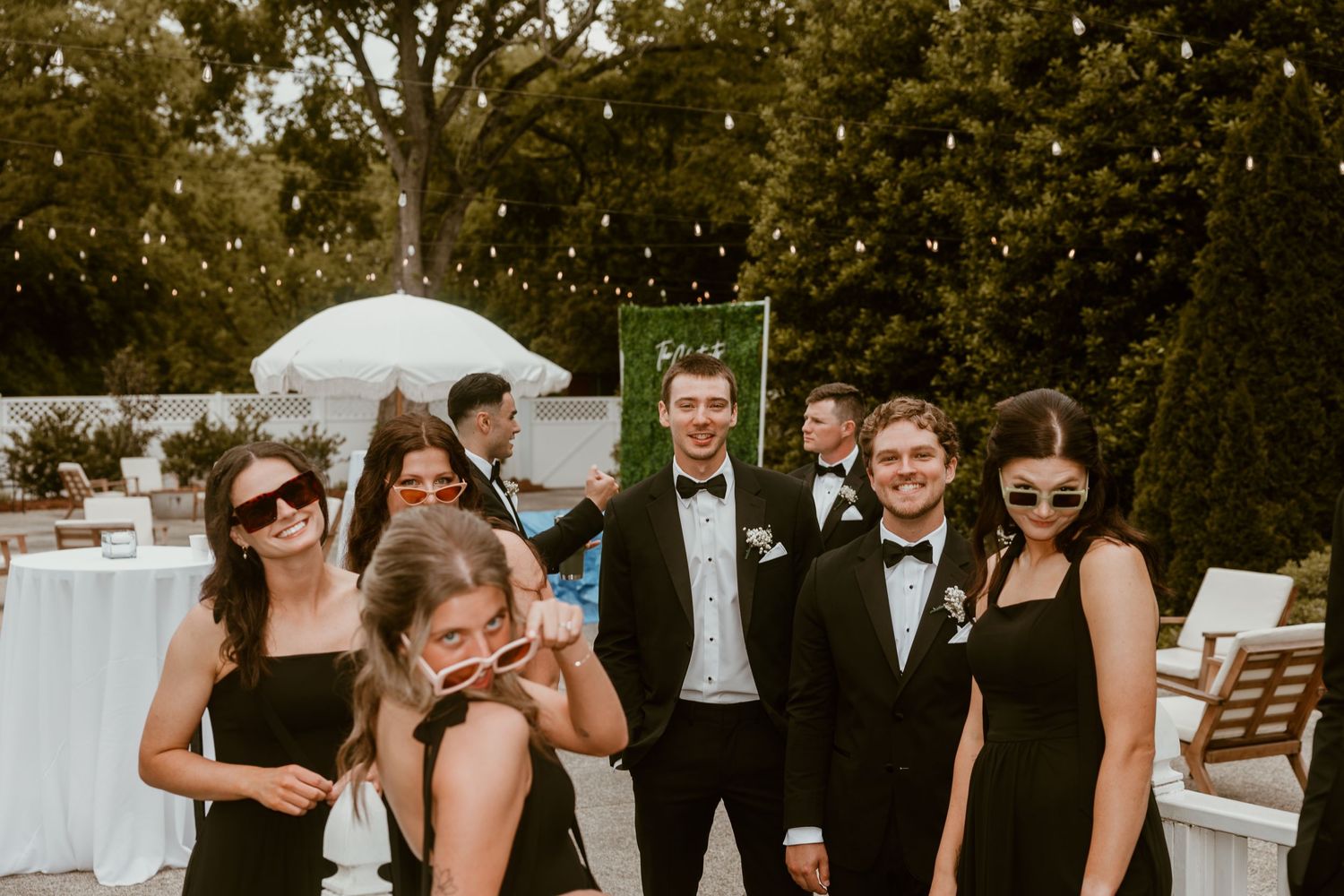Wedding guests enjoy a candid fun moment outdoors during a celebration.