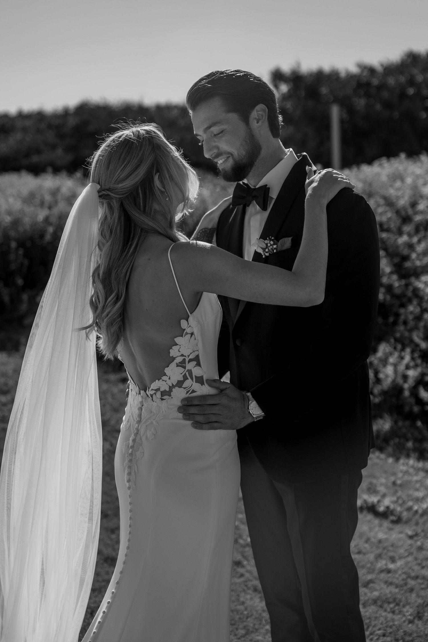 An intimate wedding couple dancing moment captured in black and white photography.