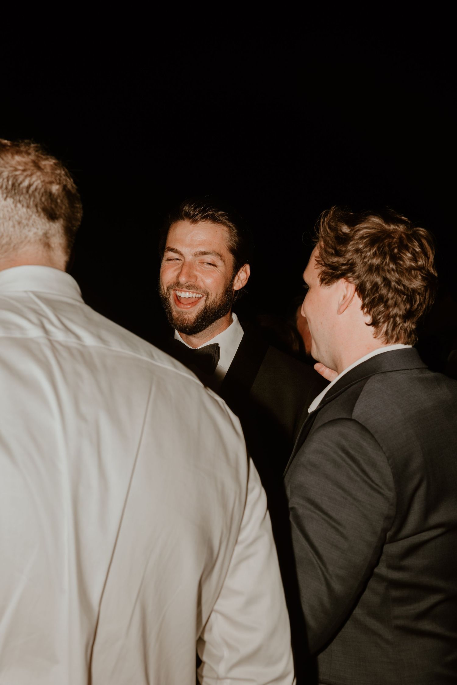 Candid black and white reception photos showing guests in formal attire.