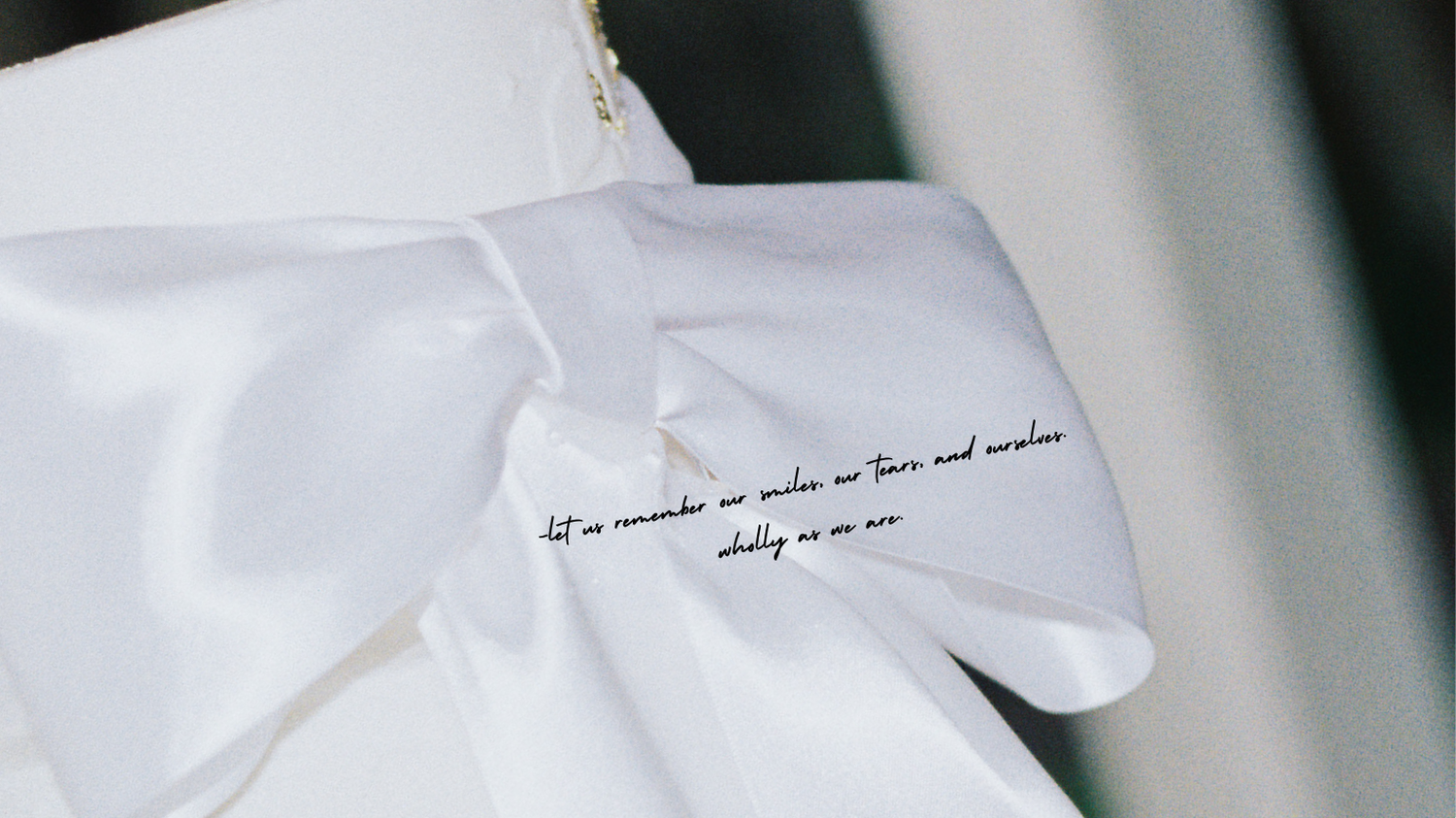 Detail of white fabric with handwritten text in natural light.