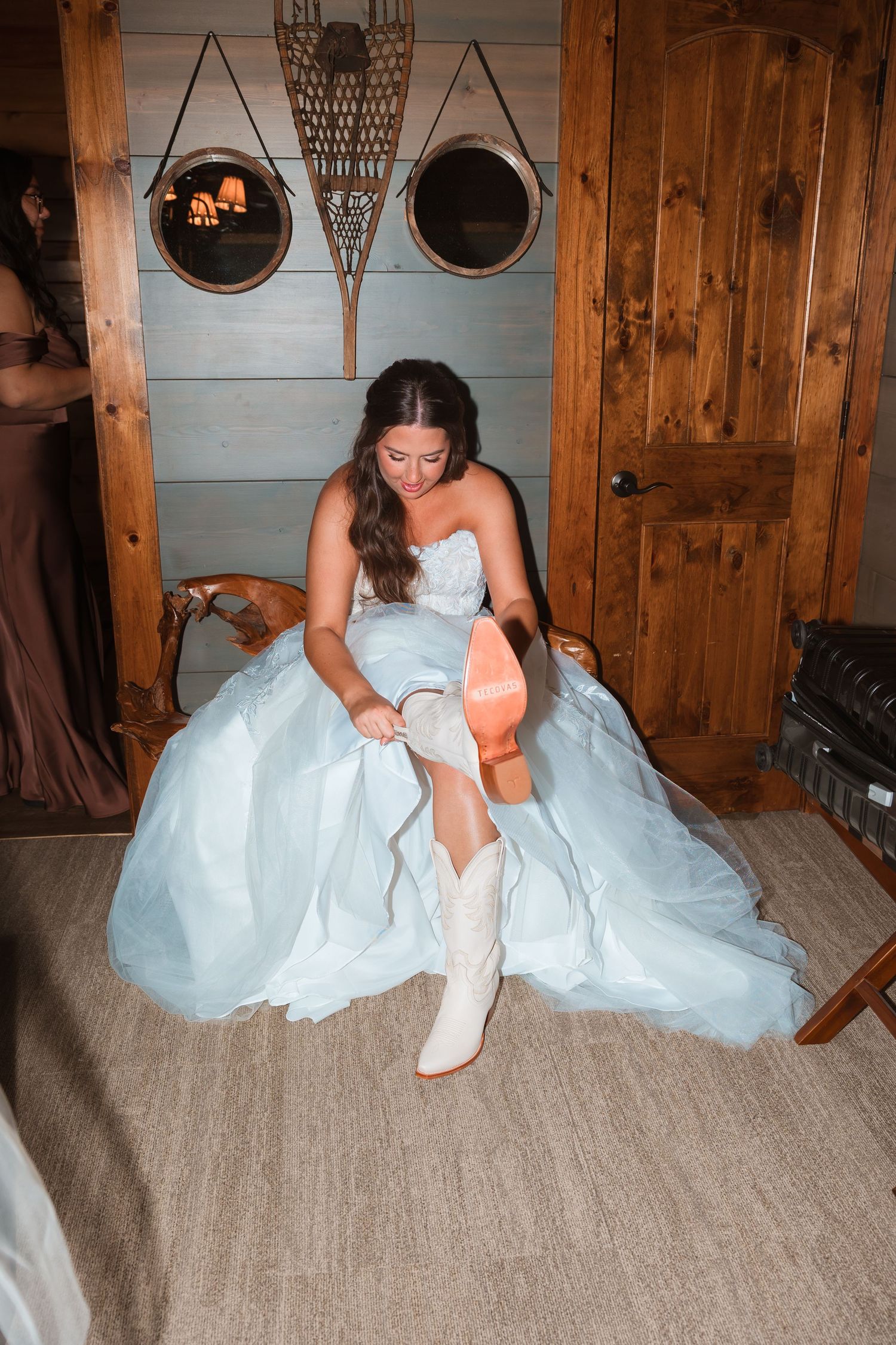 Series of shots showing a bride putting on white boots while wearing her wedding dress.