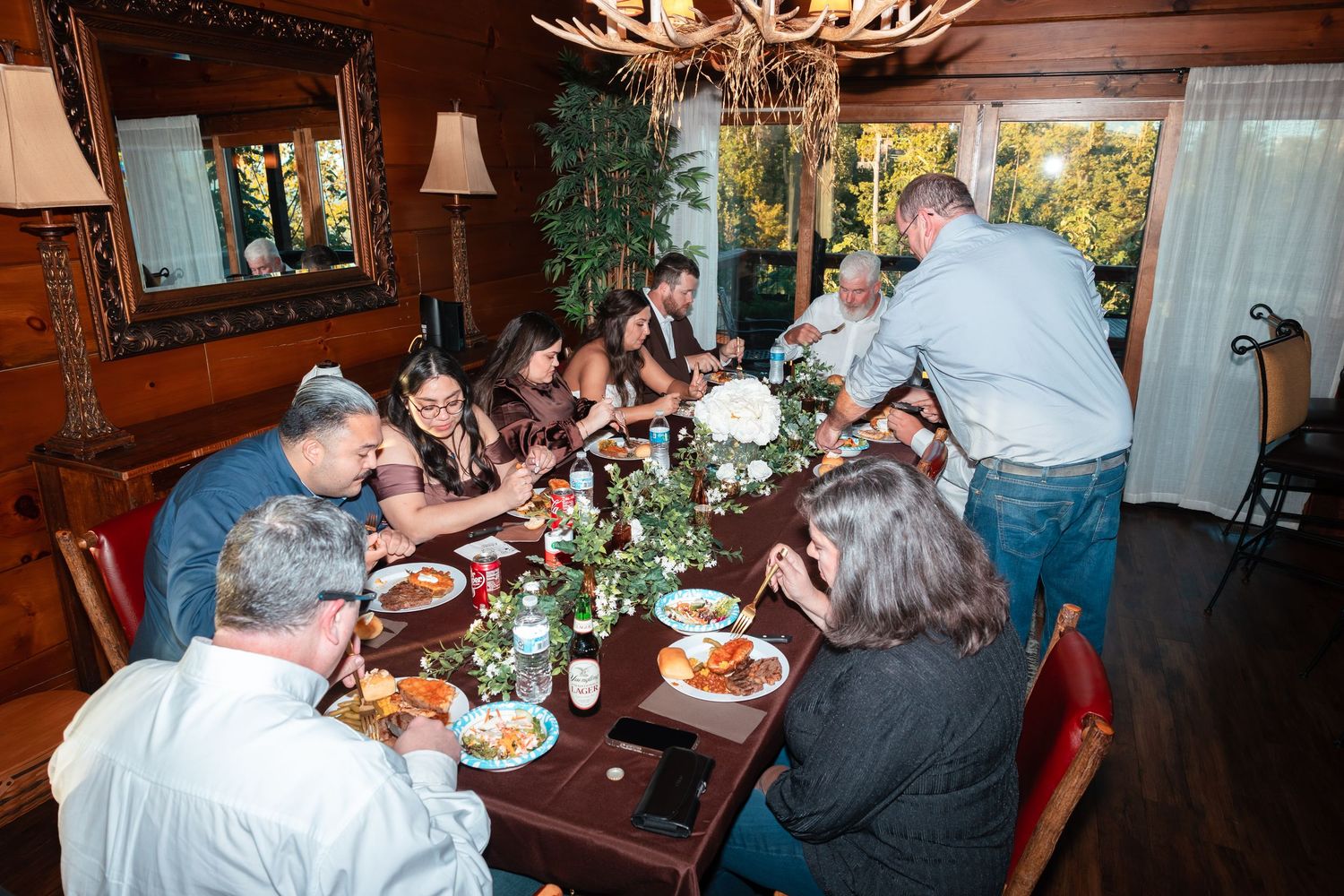 Musicians perform traditional folk music with string instruments in a cozy rustic cabin setting.