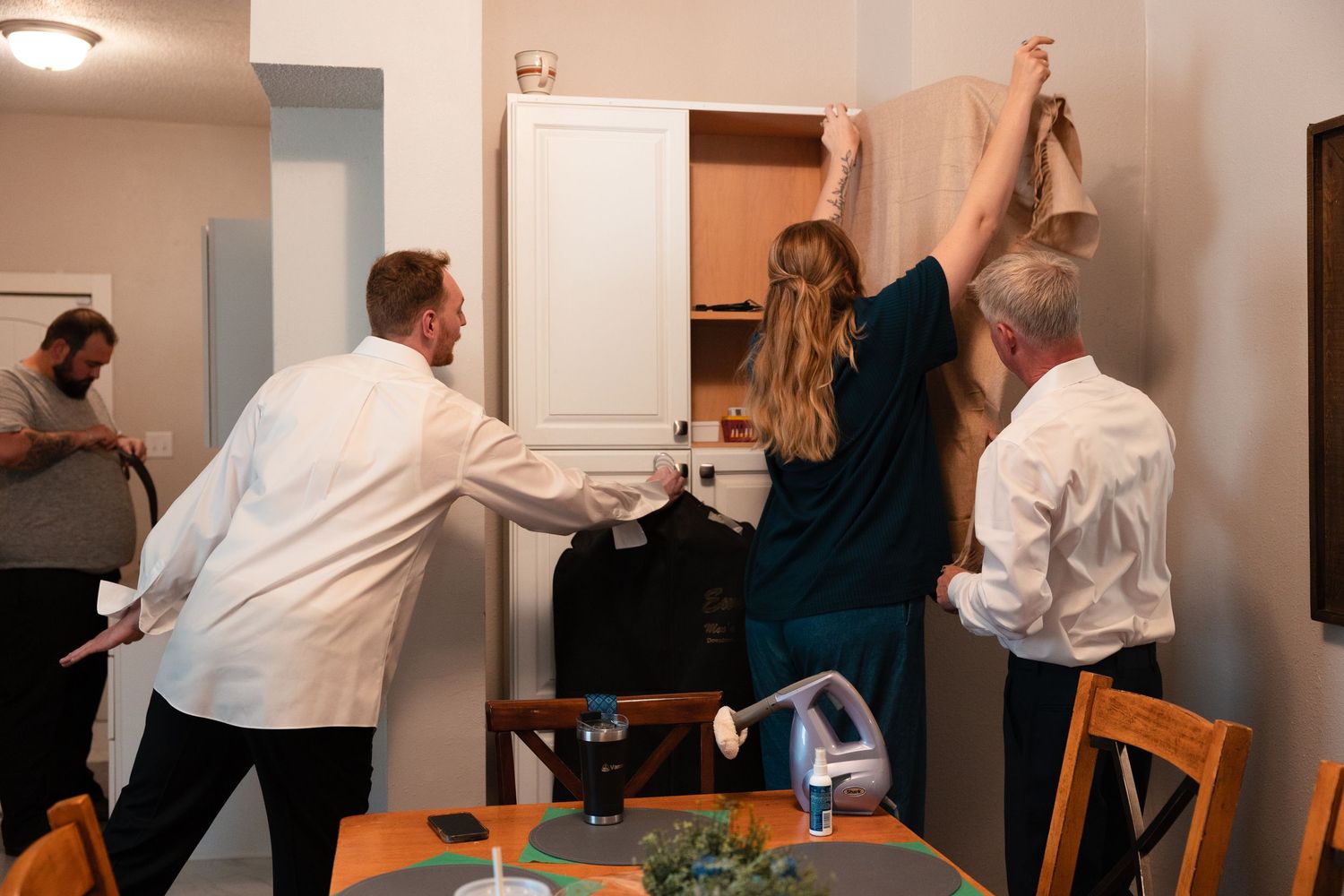 A sequence of photos showing people dancing and moving together in a white-walled room during a group activity.