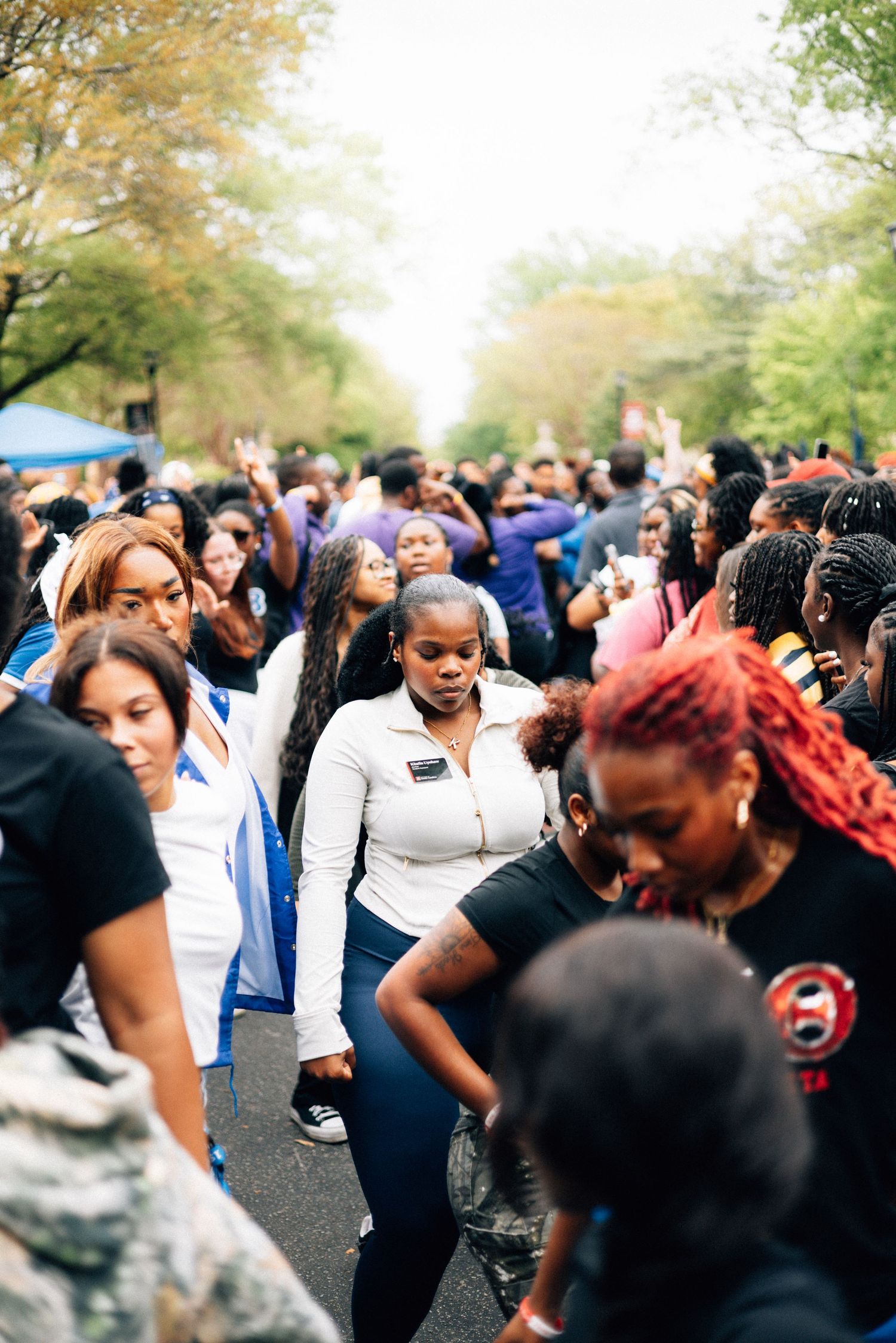 A lively Deltas of people dancing together at an outdoor social gathering in a park.