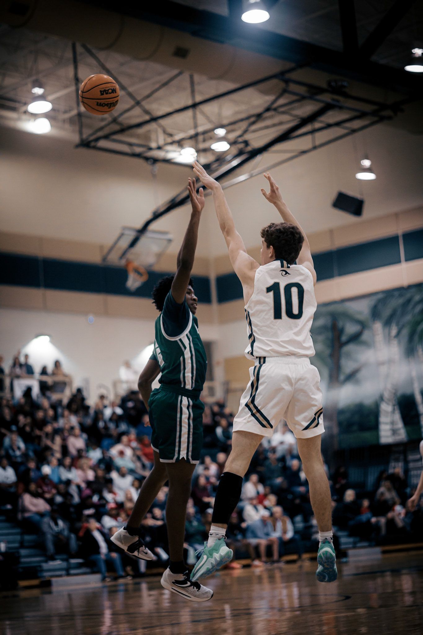 Two basketball players competing for a shot during intense game action.