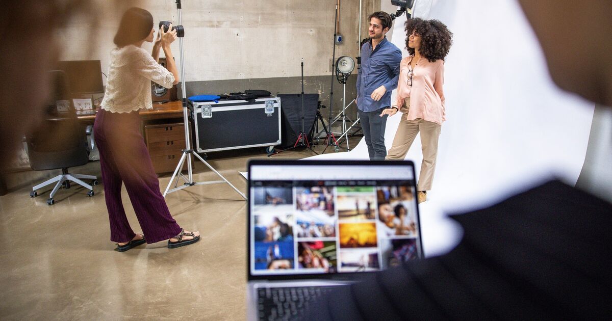Behind the scenes of video production showing camera operators and equipment setup.