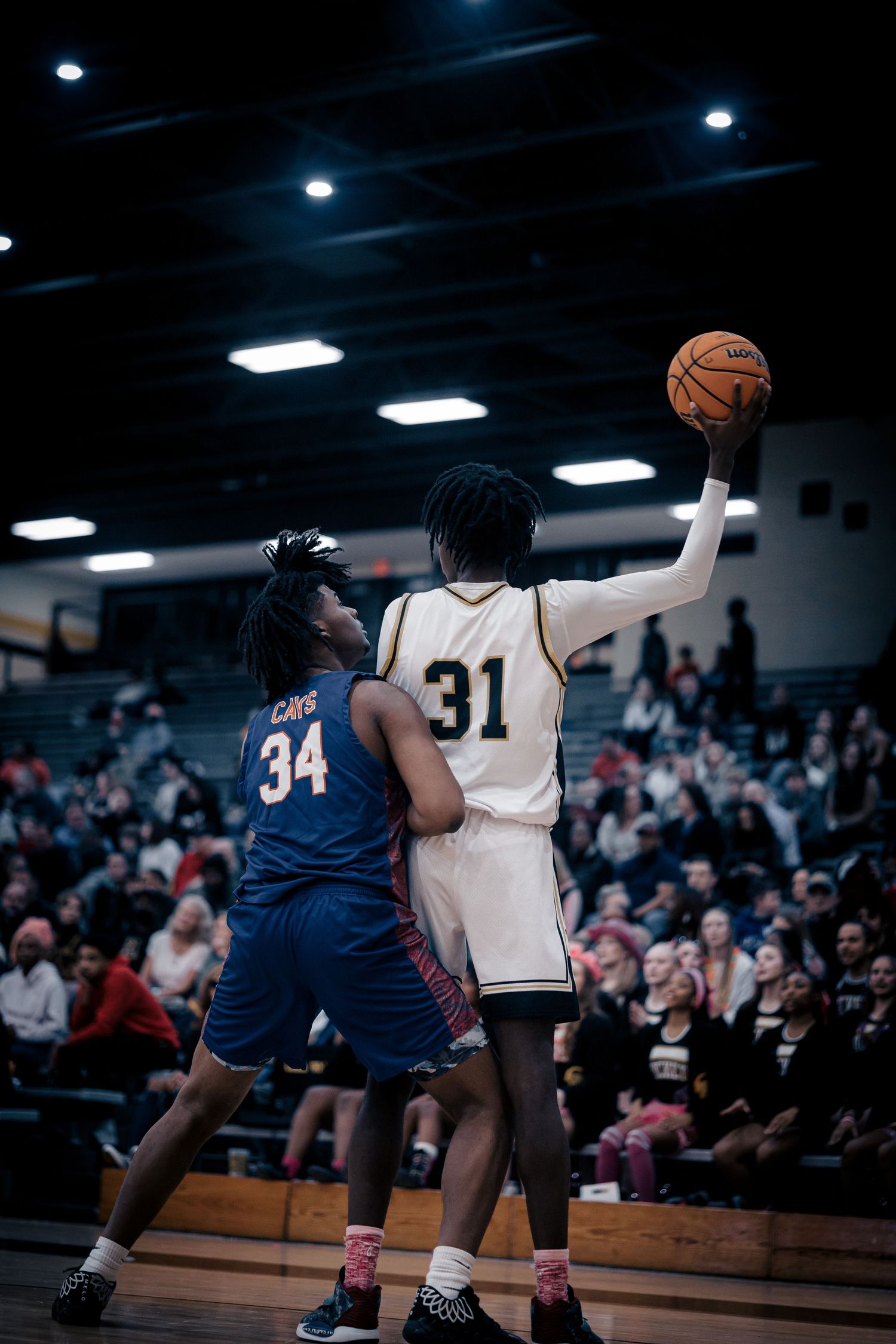 Two basketball players competing for position during intense game action.