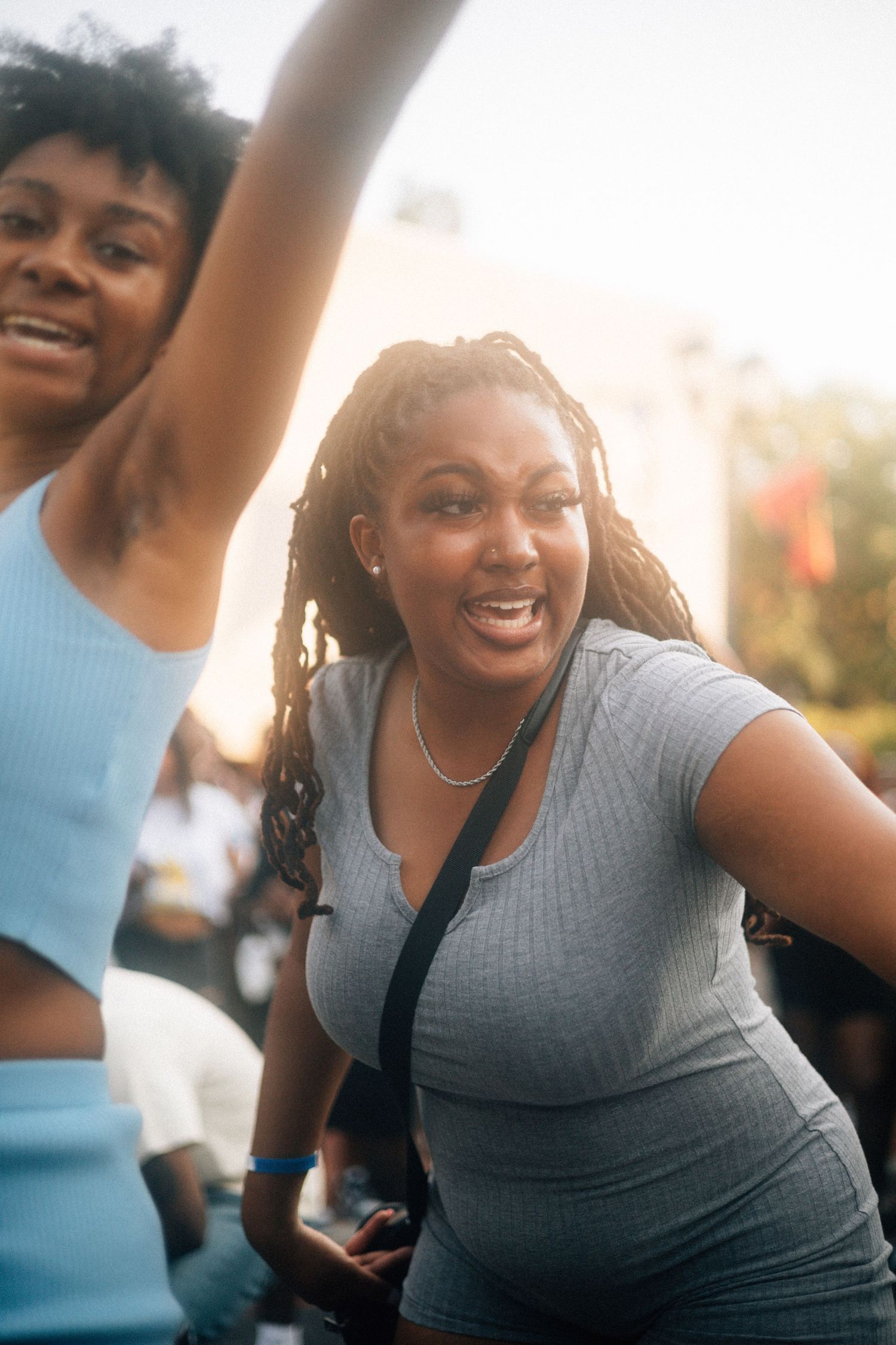 Two friends dancing together outdoors in casual athletic wear during a sunny day.  USC Hip Hop Wednesday