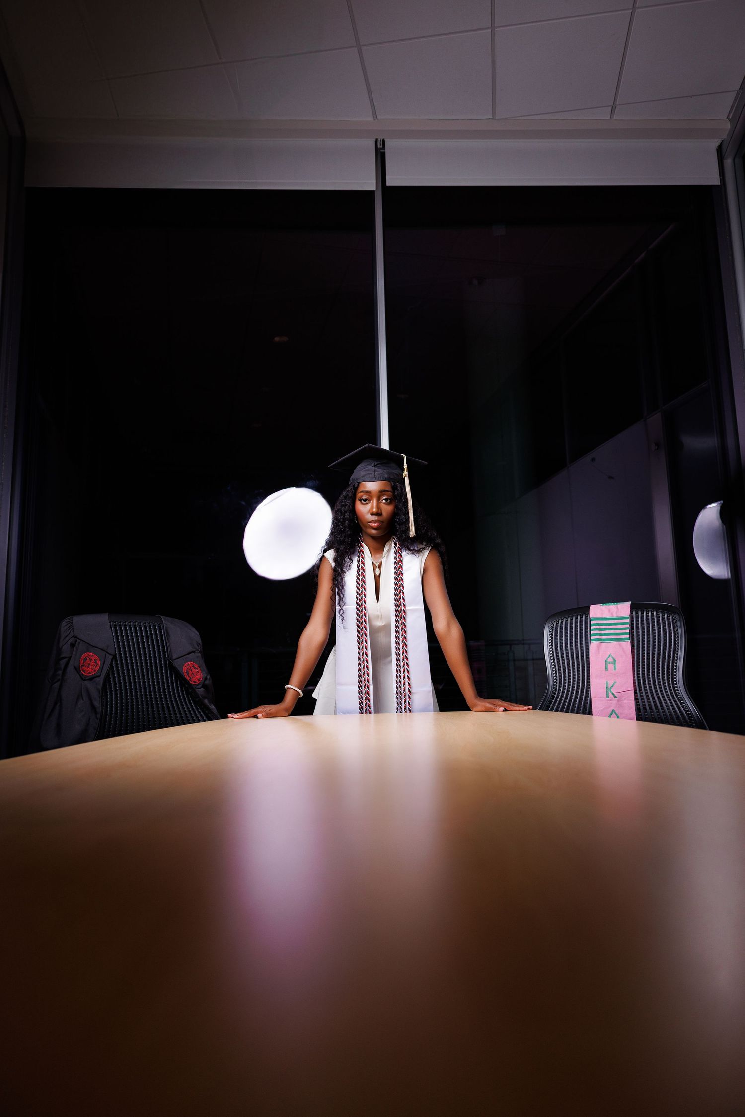 Dramatic portrait in conference room with moody lighting.