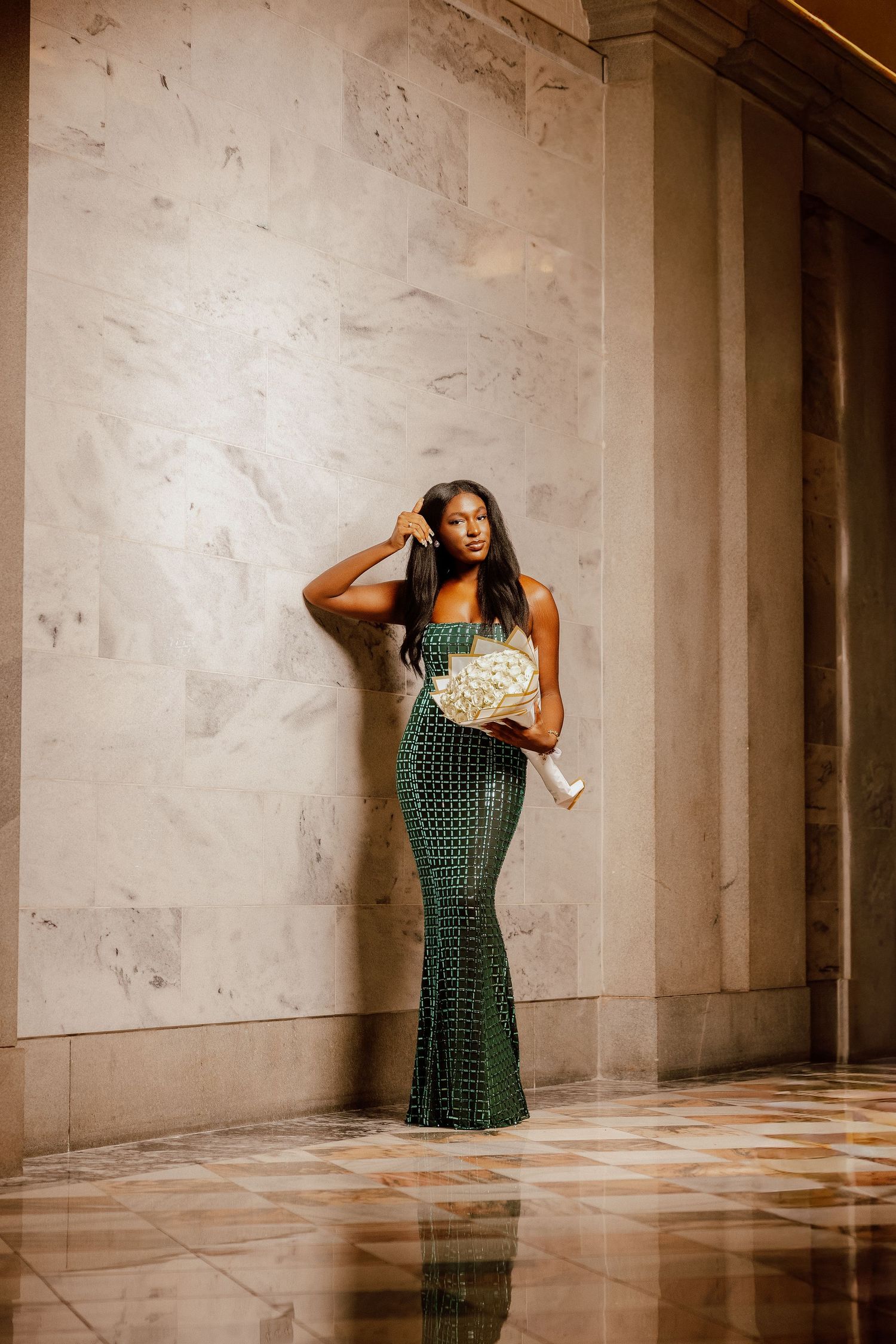 A woman in a green dress poses dramatically against concrete walls in a series of artistic dance movements.