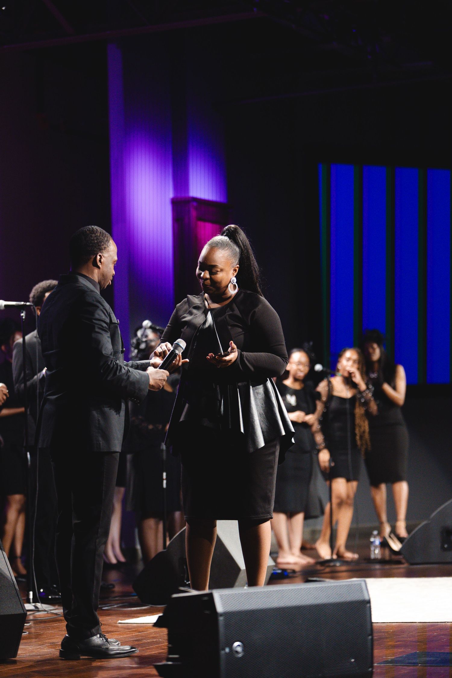 Gospel performers on stage with dramatic lighting and choreographed movements.