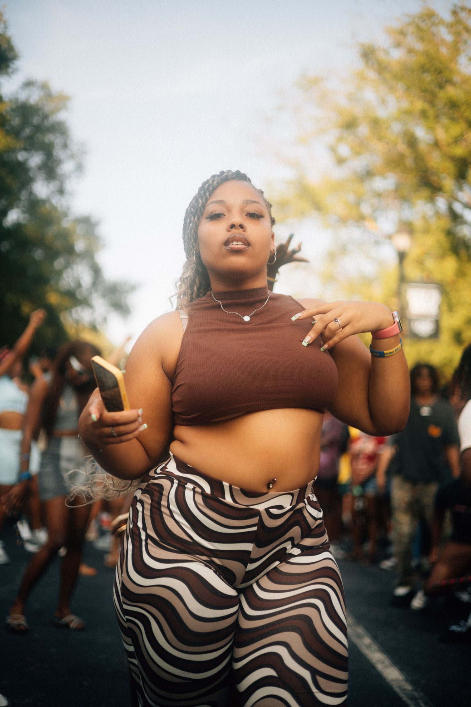 Dancing outdoors in brown crop top and black and white patterned pants during a sunny autumn day.  USC Hip Hop Wednesday