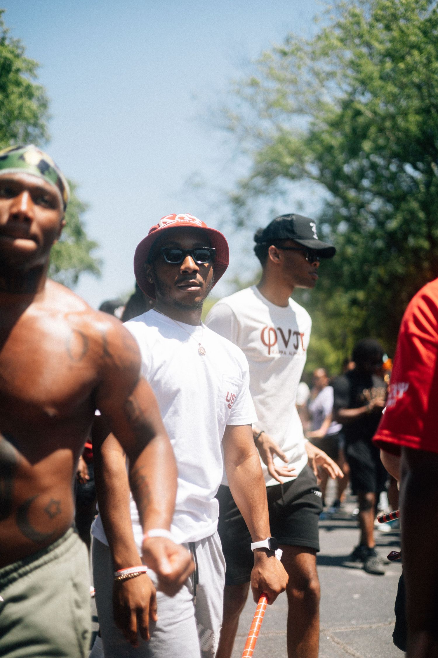 A group of people enjoying an outdoor gathering on a sunny day with green trees in the background.  USC Hip Hop Wednesday