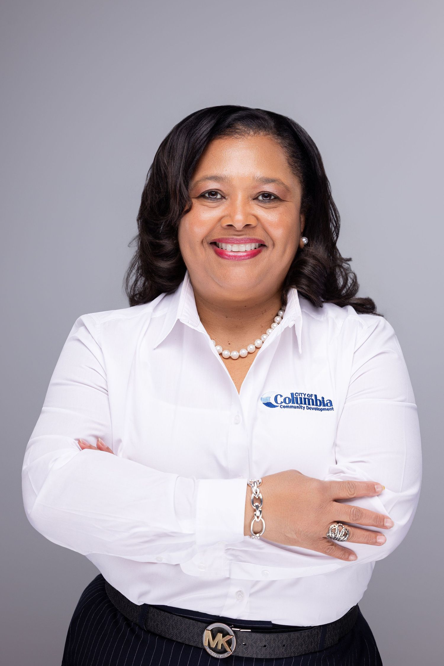 Professional headshots of someone in a crisp white button-down shirt against a grey background showing different poses.