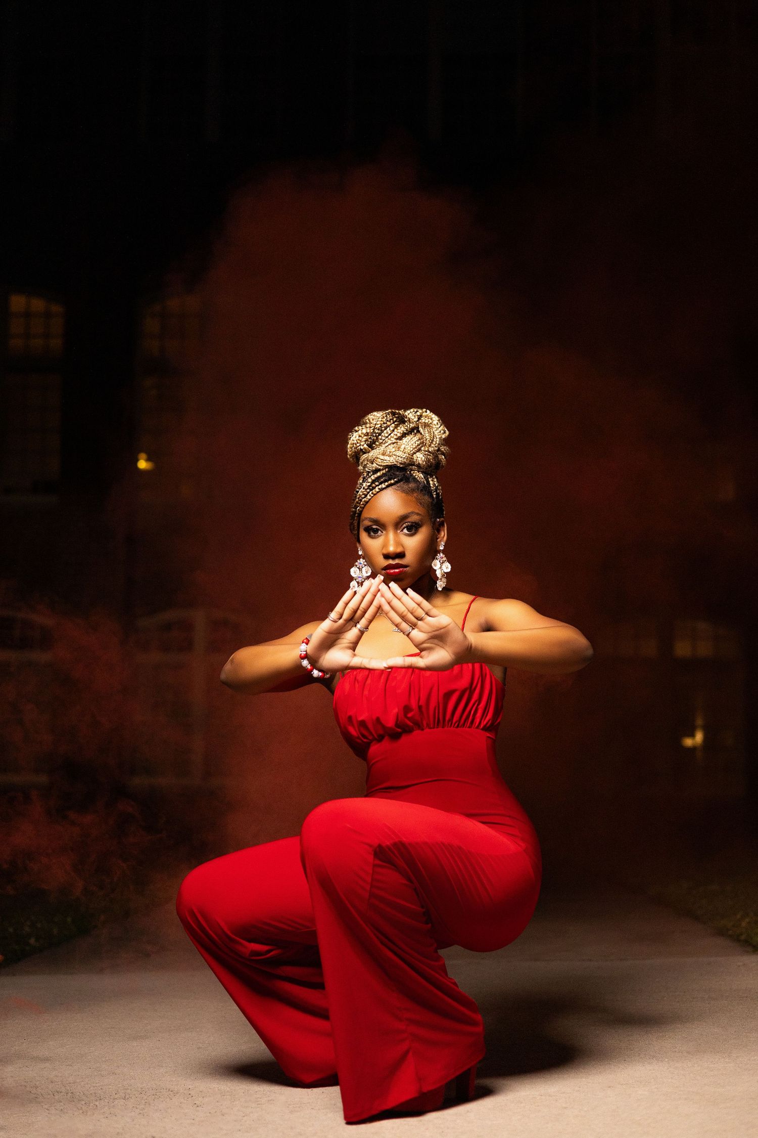 Flowing red dress movement captured in dramatic lighting with smoke effects.