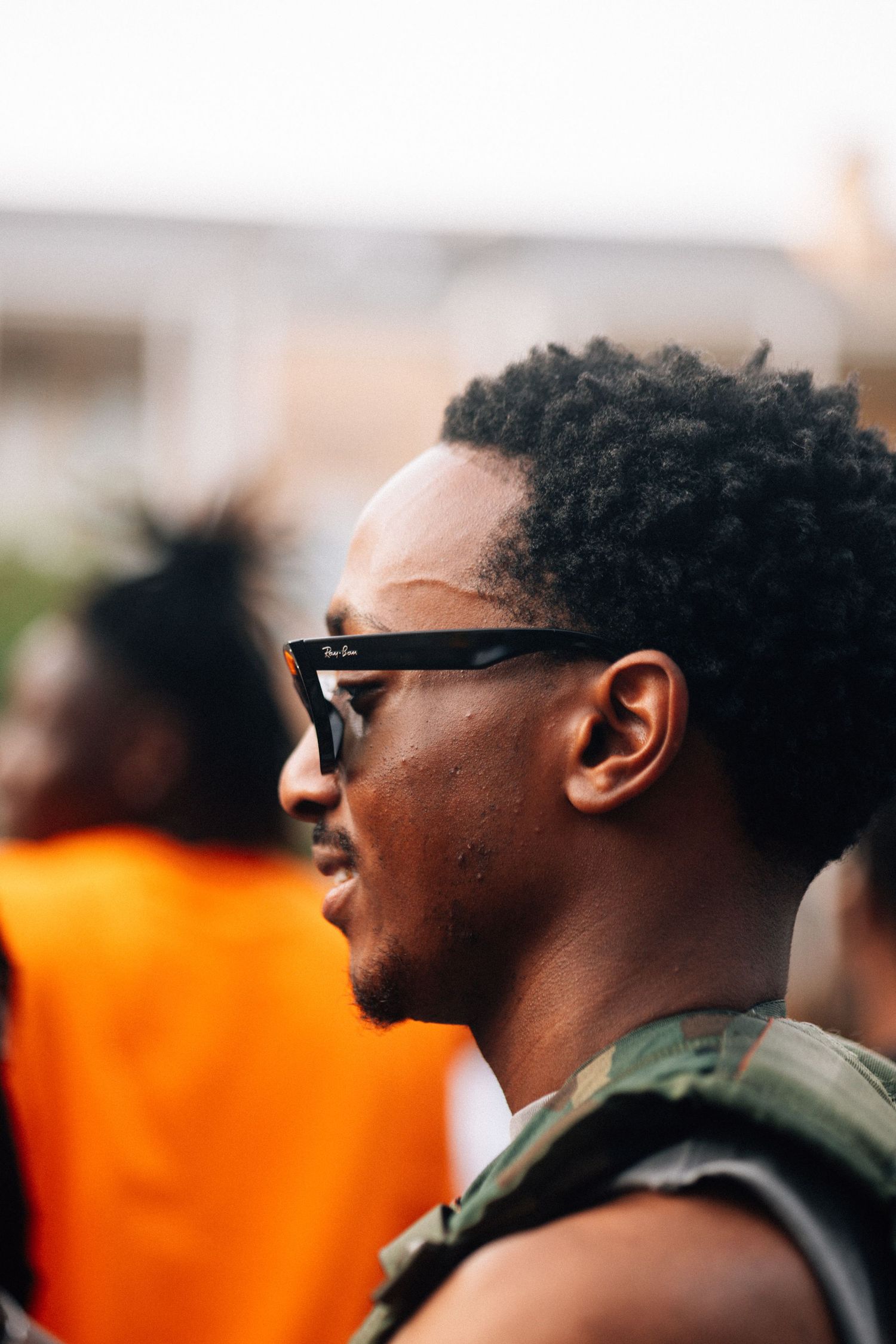 A profile sequence shows a person wearing sunglasses and a dark sleeveless top against a blurred background.