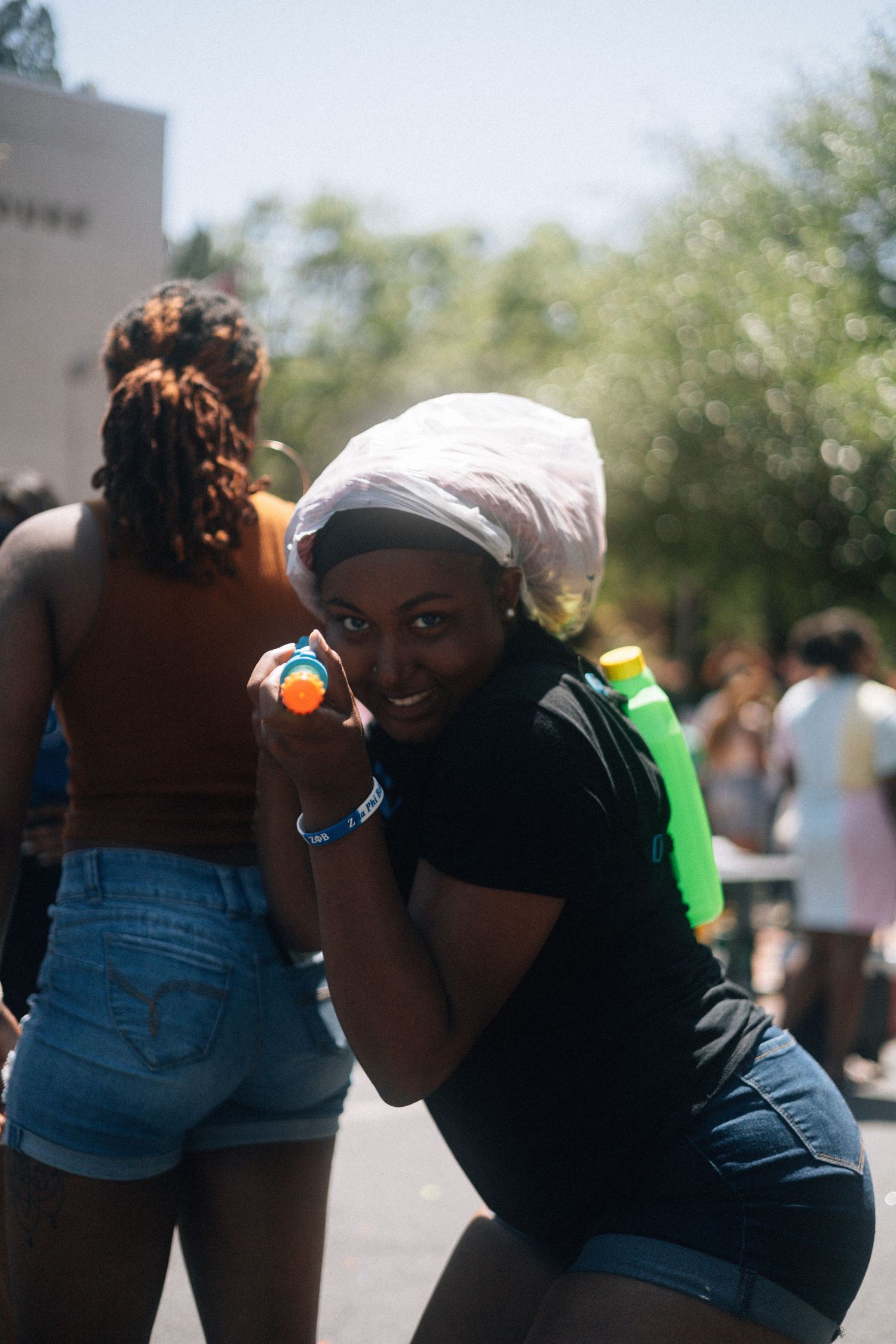 A sequence of candid moments captured at an outdoor event shows people in denim shorts embracing and interacting.  USC Hip Hop Wednesday