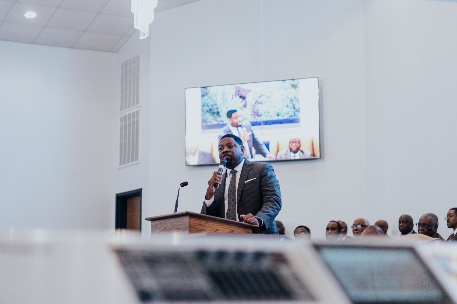 Business professionals gathered in a modern conference room for a corporate presentation and discussion.