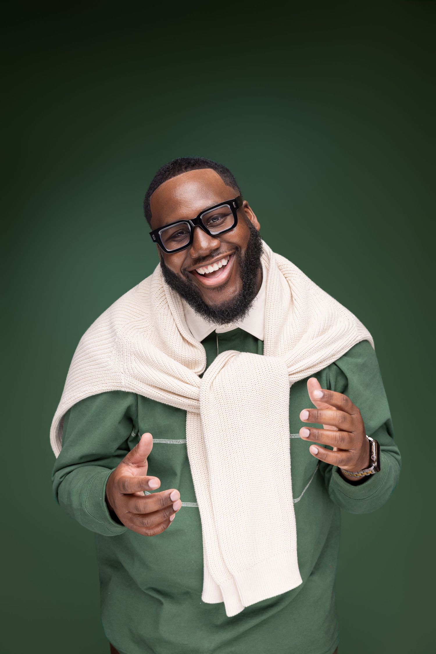 A series of expressive photos showing someone in a green sweater and glasses posing with a white scarf against a green background.