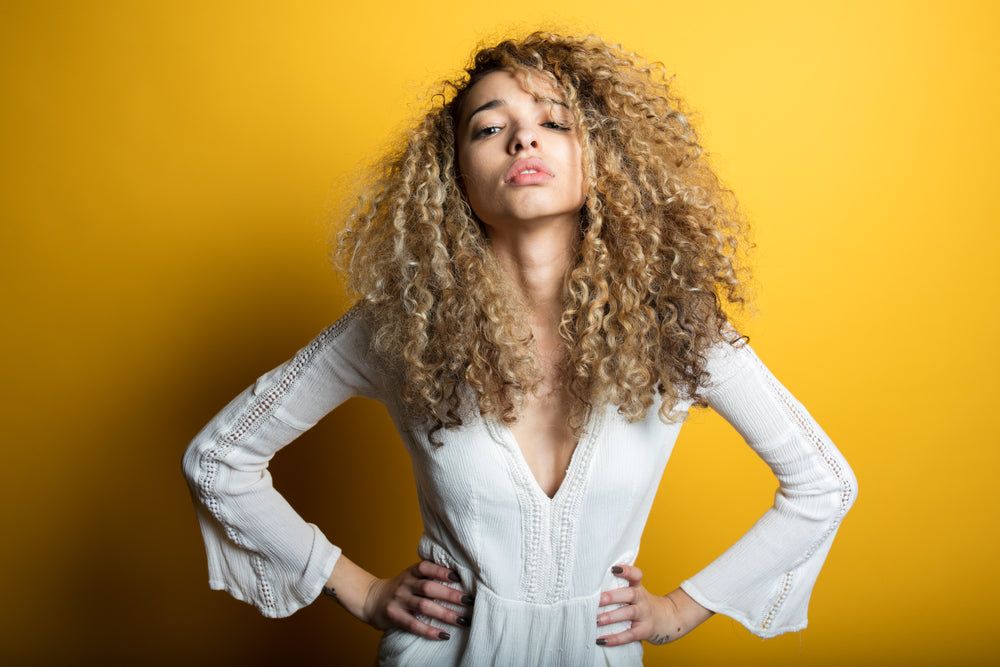 Creative portrait series against vibrant yellow background featuring dynamic poses.
