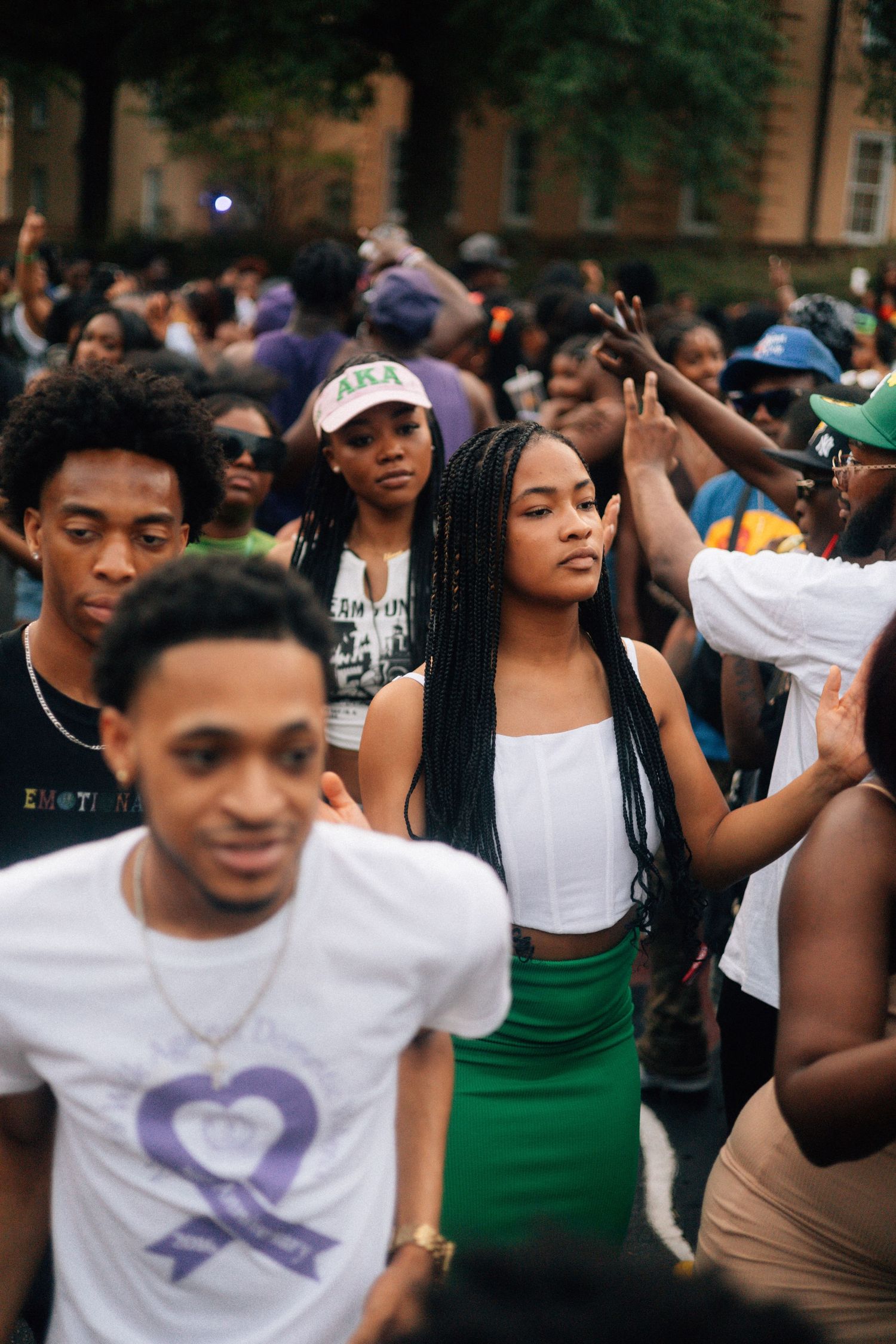 A crowd of AKA people dancing and celebrating outdoors at a lively daytime gathering. USC Hip Hop Wednesday