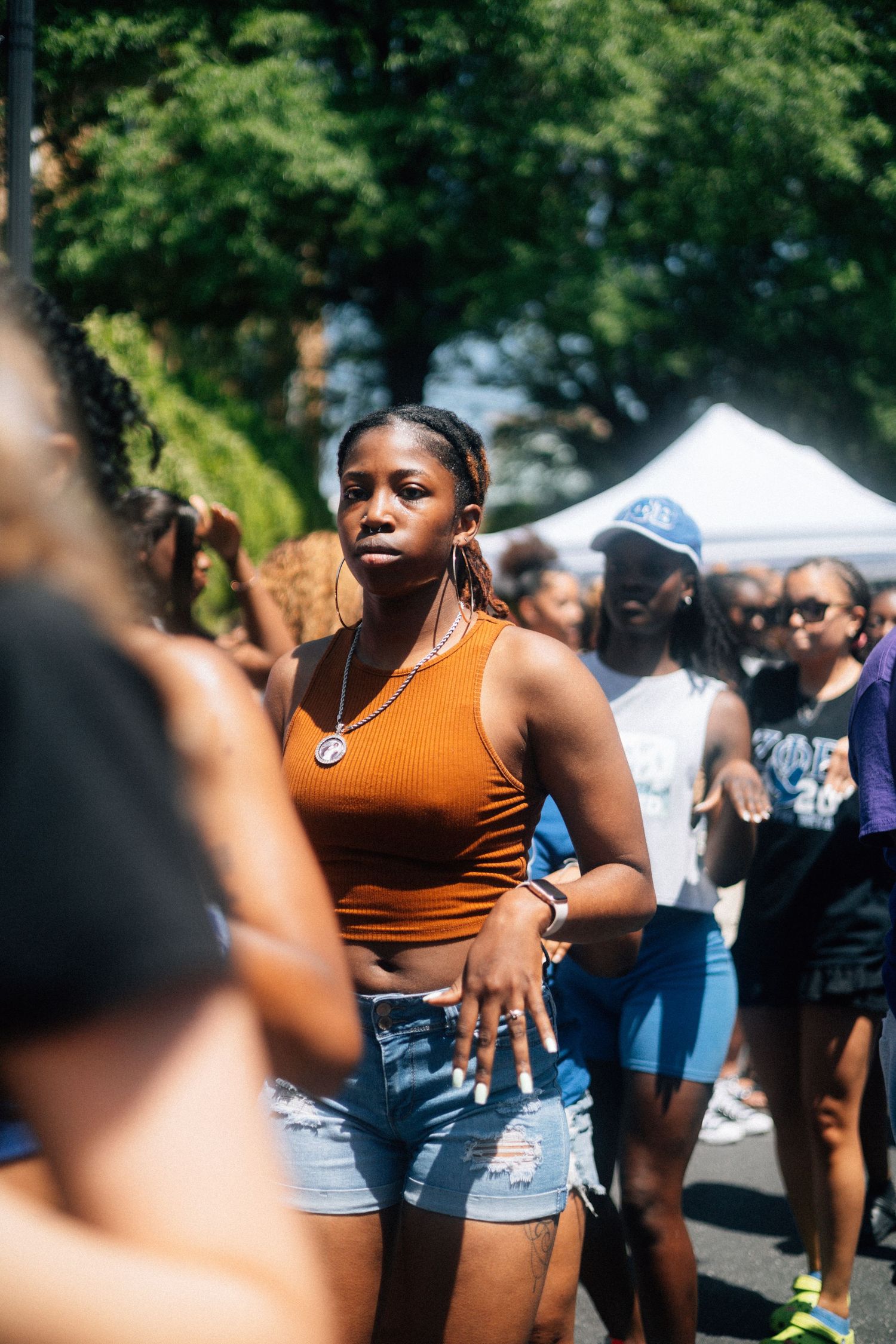 People enjoying a summer outdoor festival with tents and crowds in the background.USC Hip Hop Wednesday