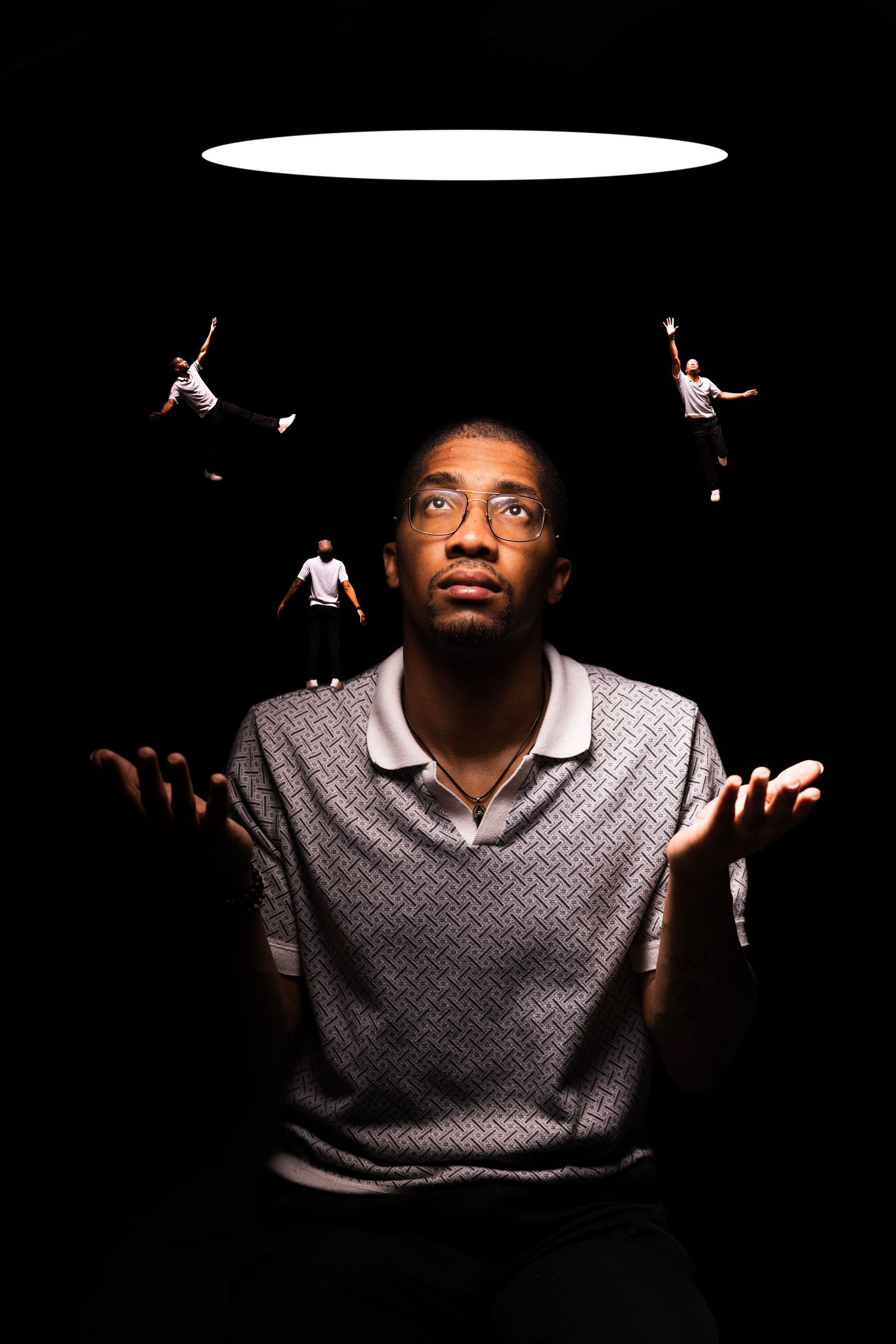 A dramatic low-key portrait series on black background showing someone in a patterned sweater with expressive hand gestures.