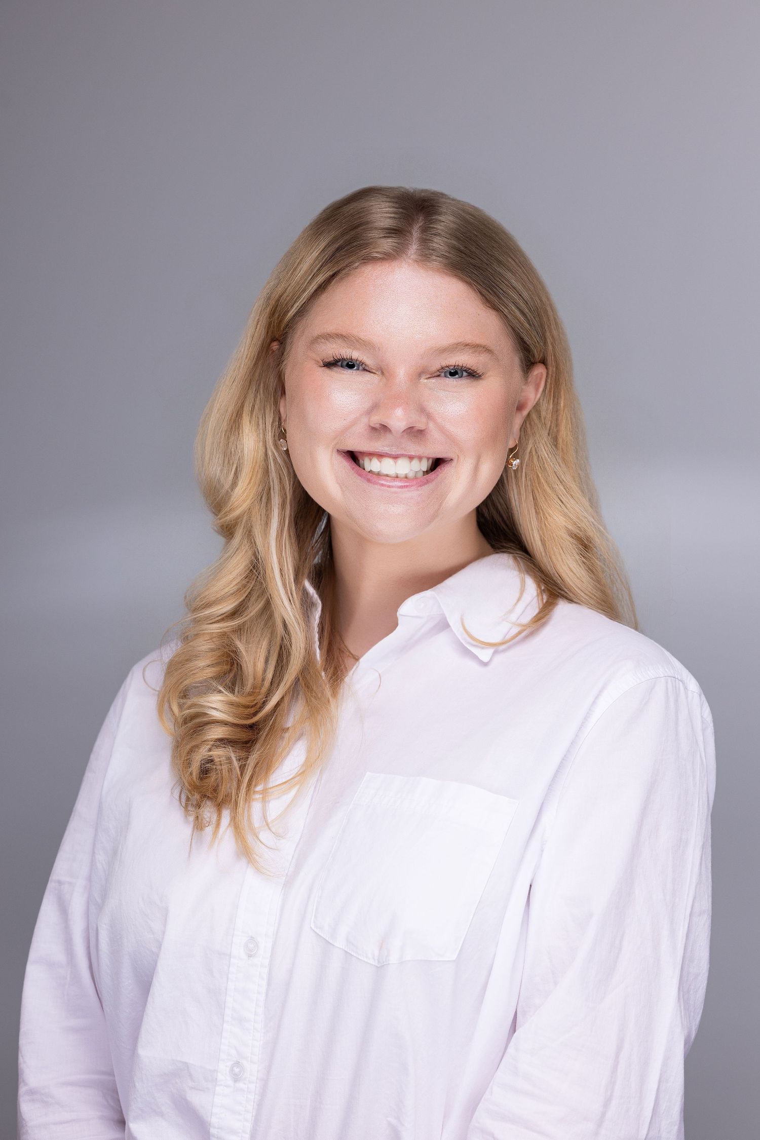 Professional headshots showing person in white button-down shirt against gray background with warm expressions.