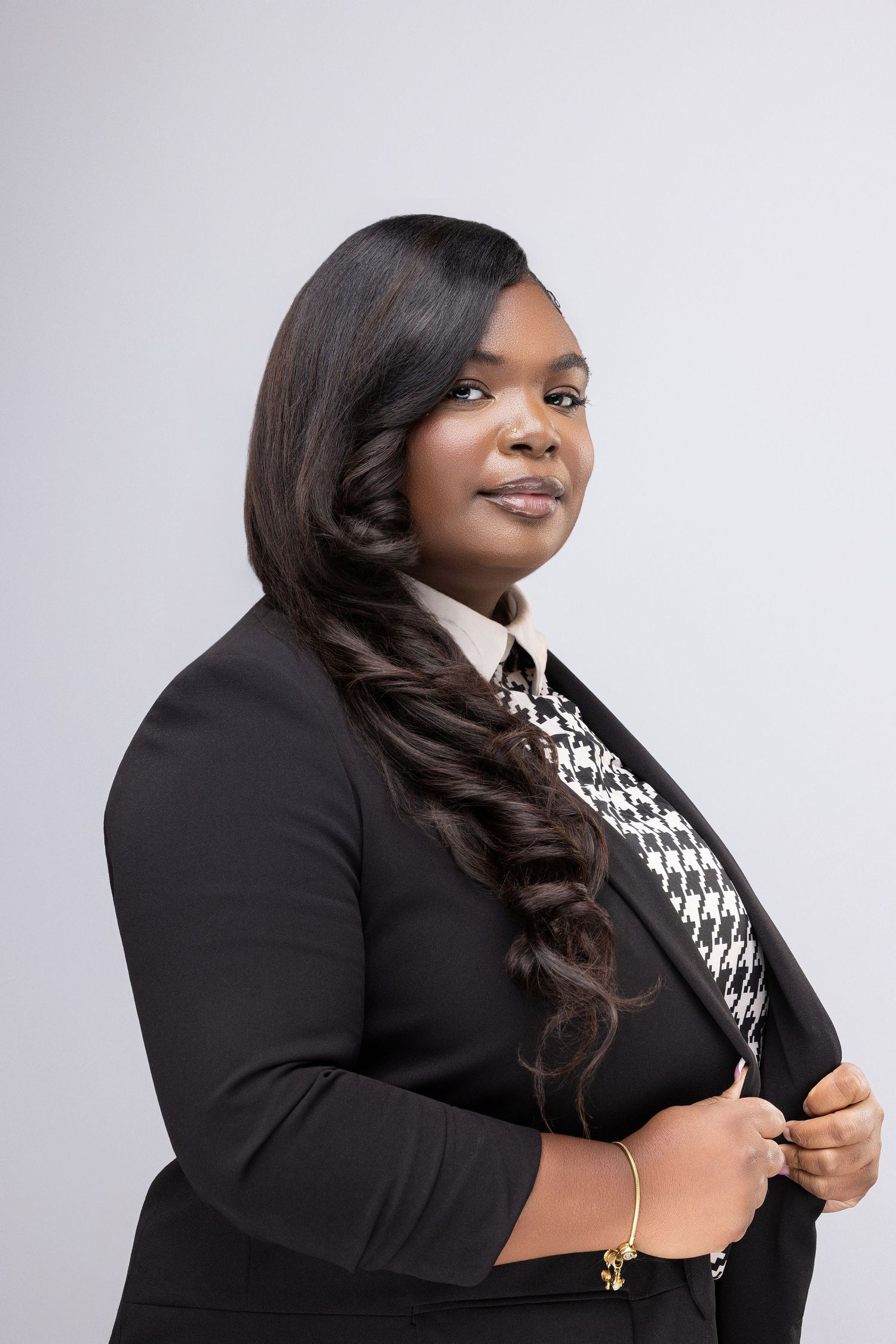 Professional portrait series showing a person in a black blazer posing against a light gray backdrop.