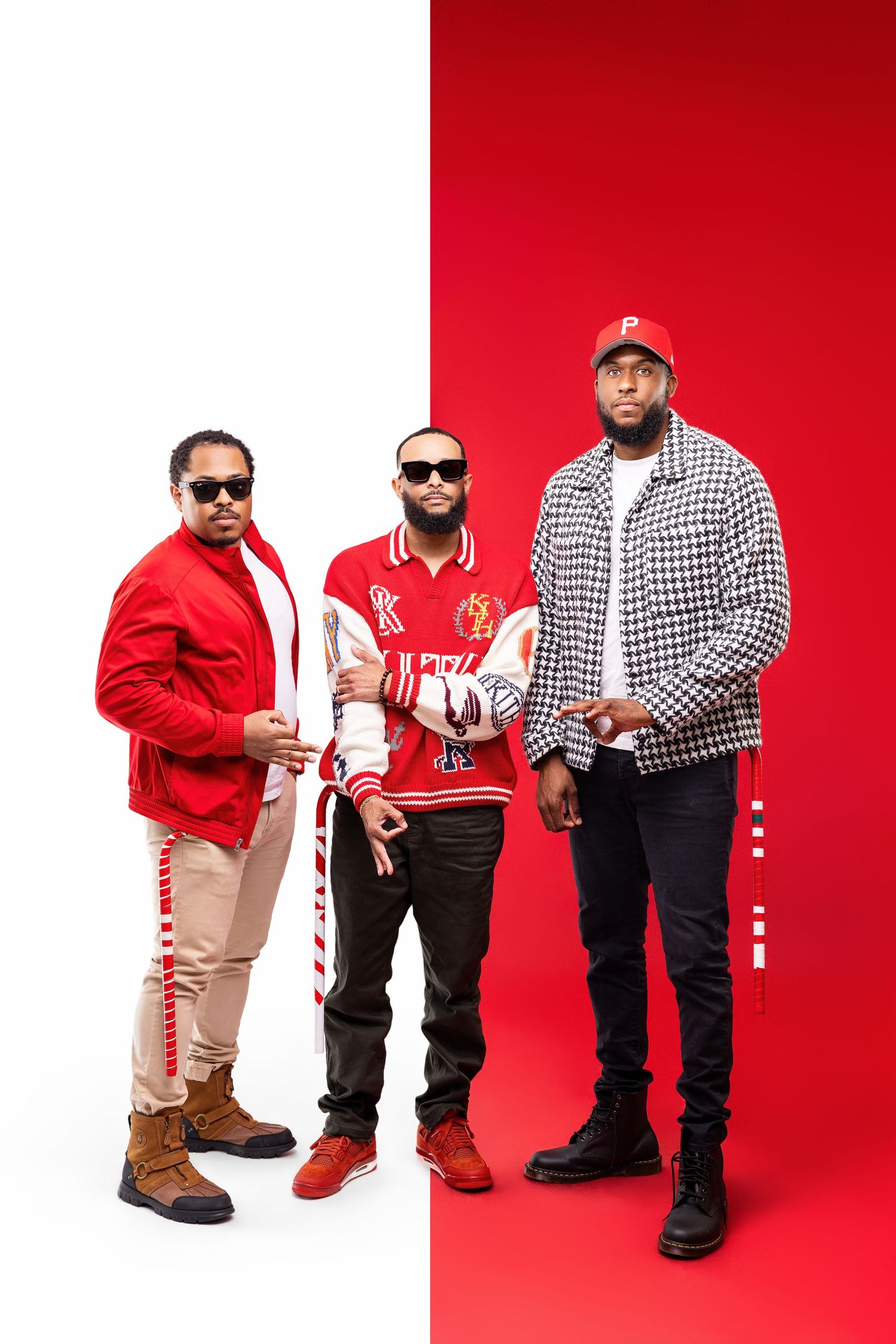 Three people pose in stylish streetwear against a split red and white background.