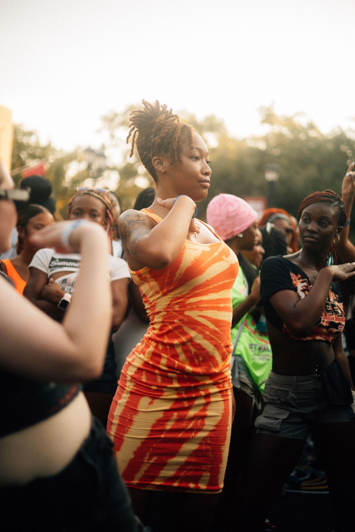 A group of zetas move energetically during an outdoor event at sunset.  USC Hip Hop Wednesday