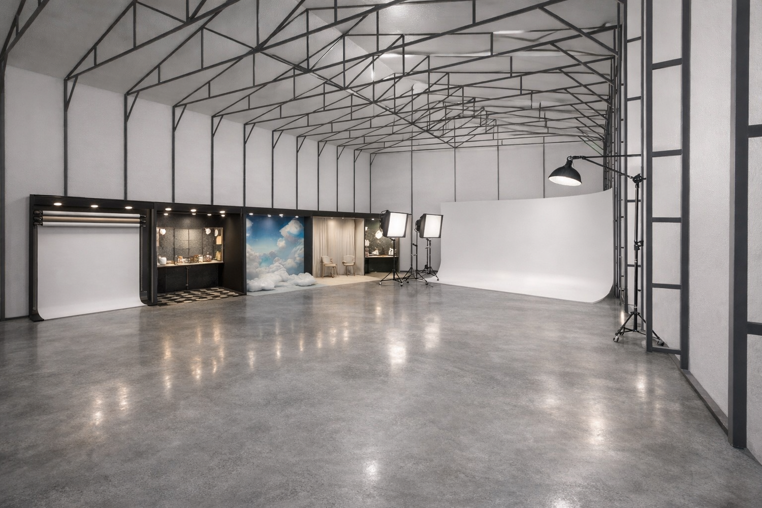 Modern industrial warehouse interior with exposed steel trusses and polished concrete floor illuminated by overhead lighting.