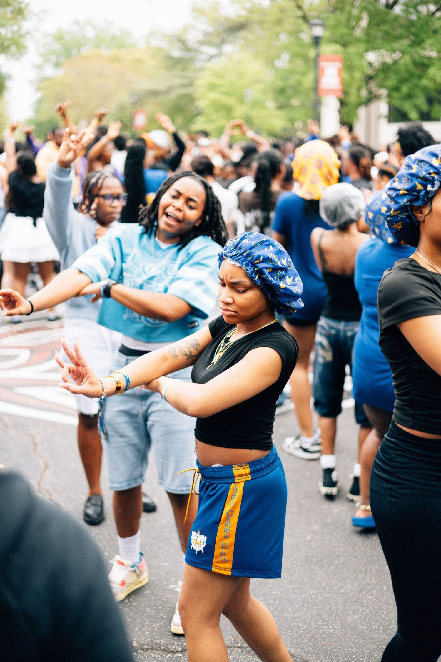 People dancing and celebrating at an outdoor community event or festival with a lively, energetic atmosphere.