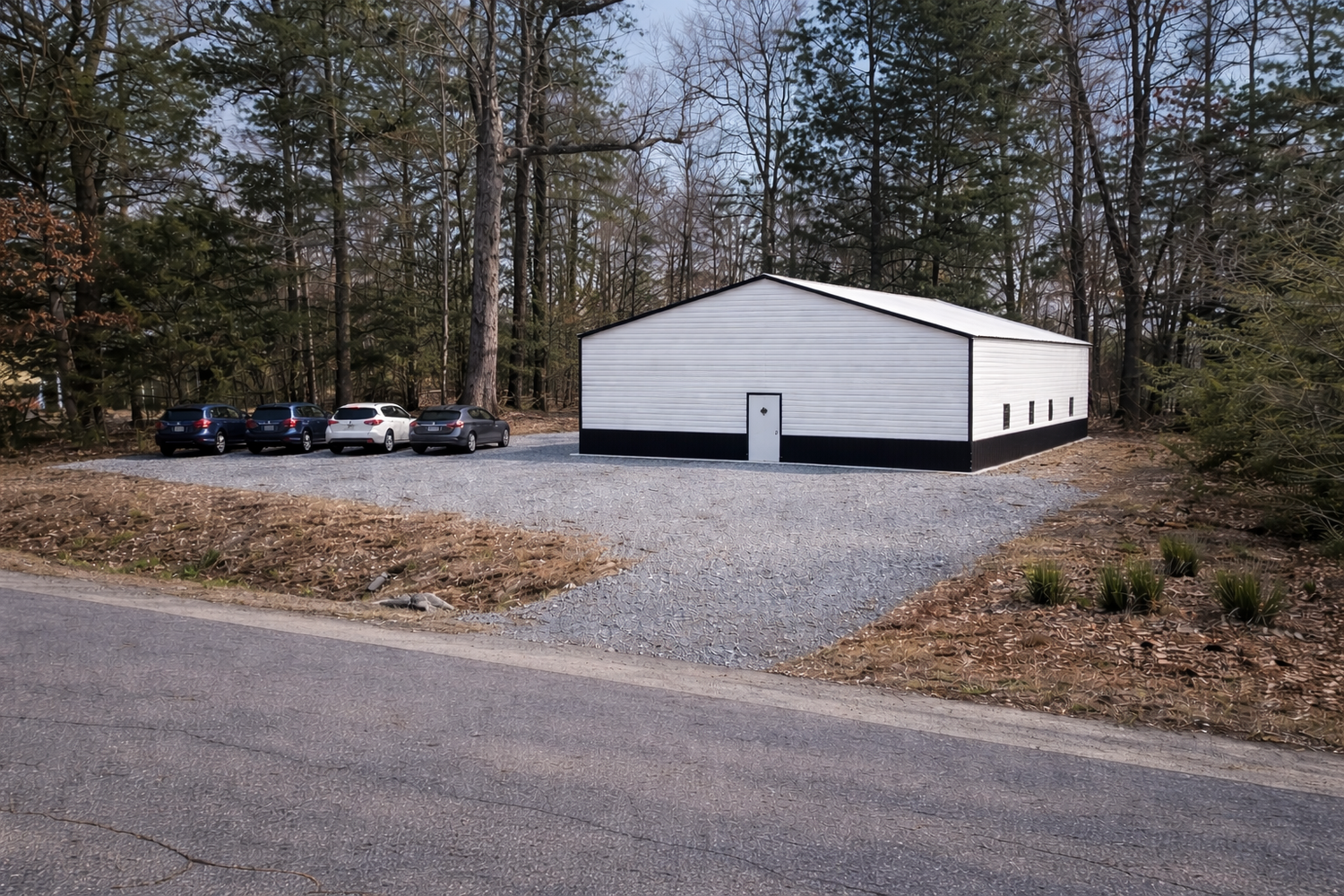 A series of gravel driveways and parking areas surrounded by pine trees and forest landscape.