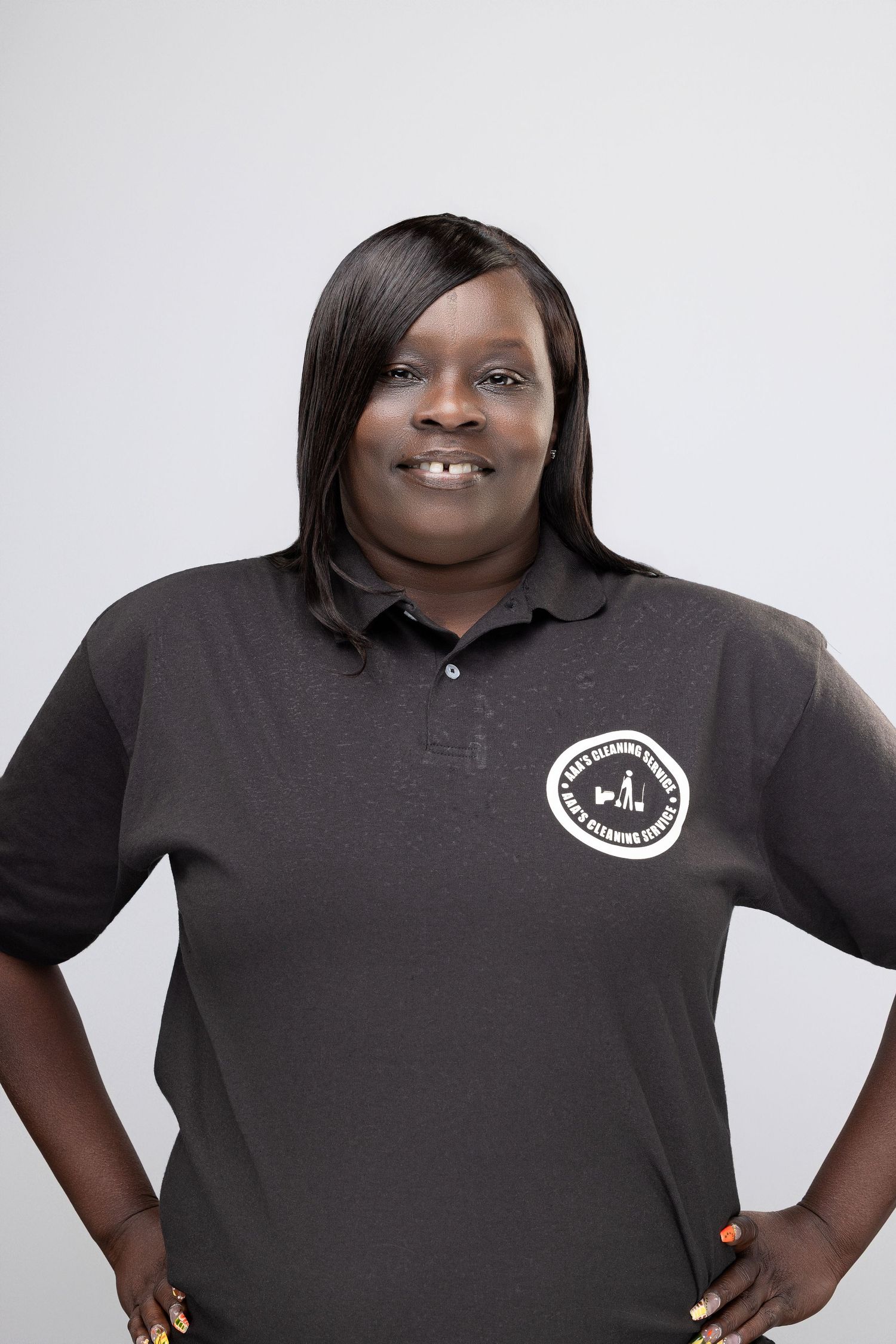 A person wearing a black polo shirt with a logo stands confidently with hands on hips in multiple poses.
