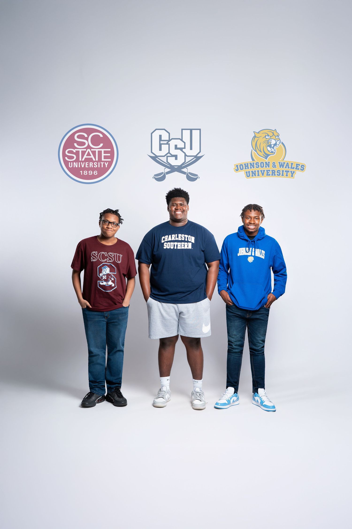 Three students pose in college apparel for SC State, Charleston Southern, and Johnson & Wales University.