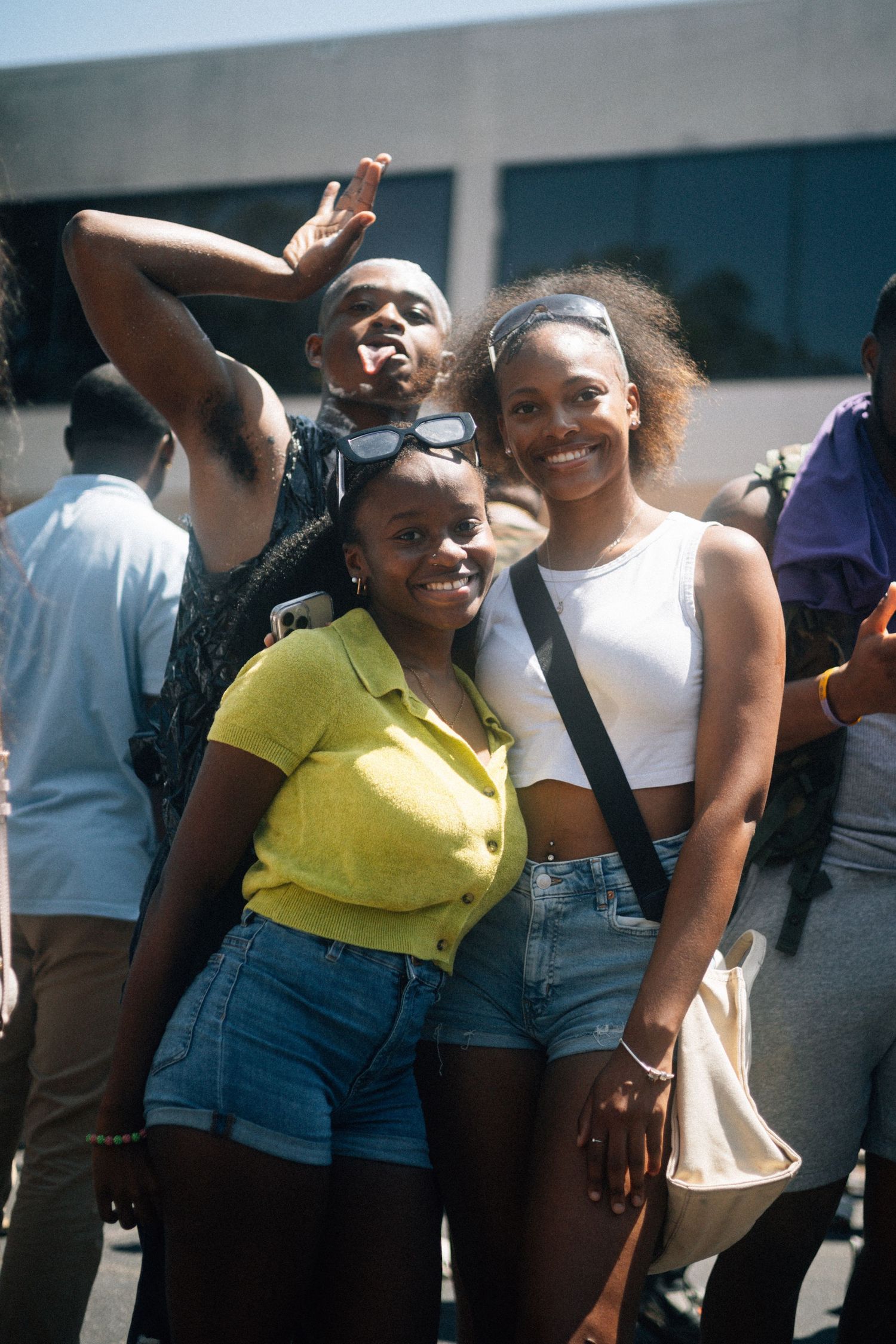 A group of people dancing and laughing together outdoors while wearing casual summer clothes.  USC Hip Hop Wednesday