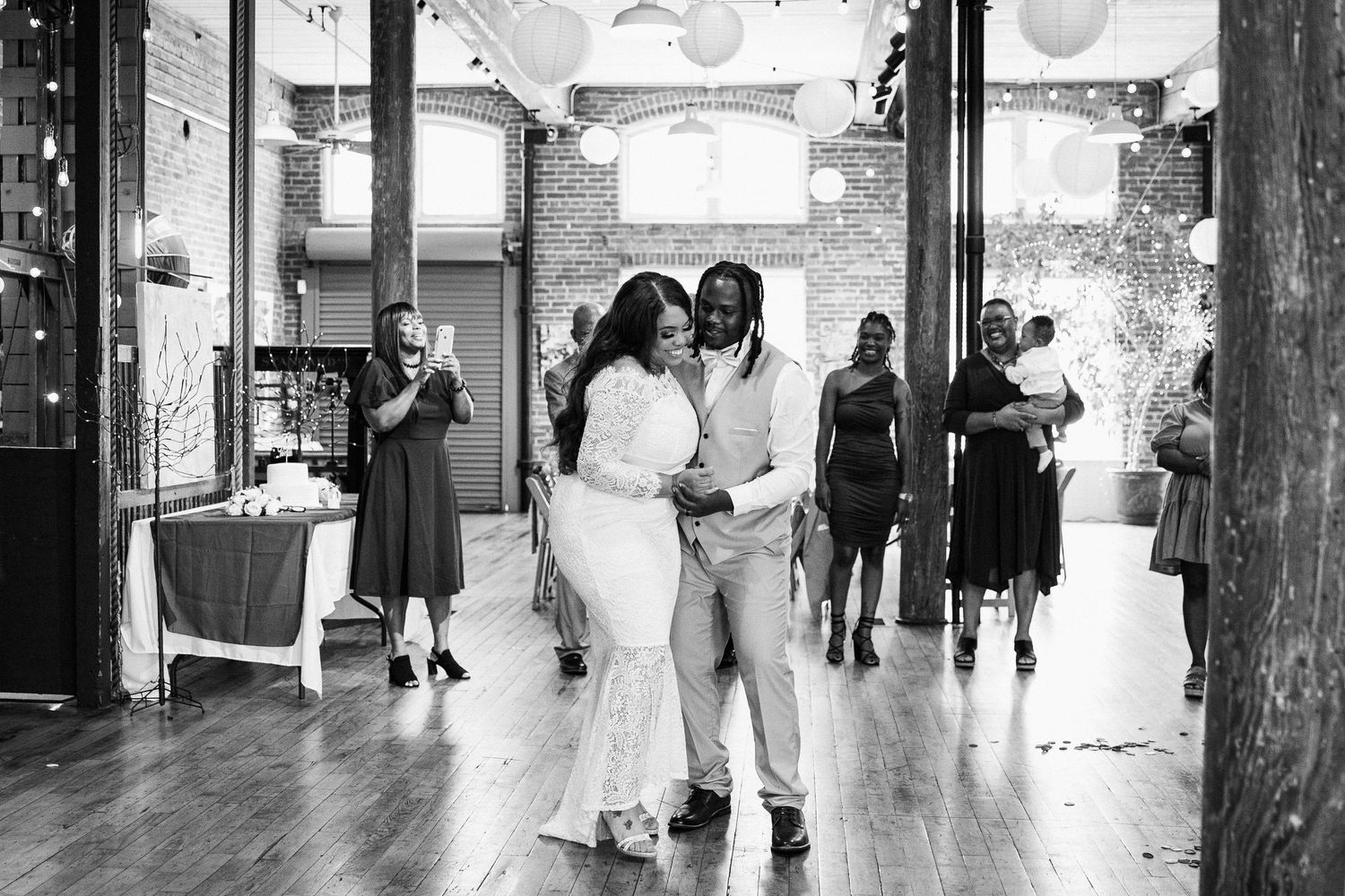 A black and white panoramic collage showing multiple wedding scenes with couples and guests in an elegant indoor venue.