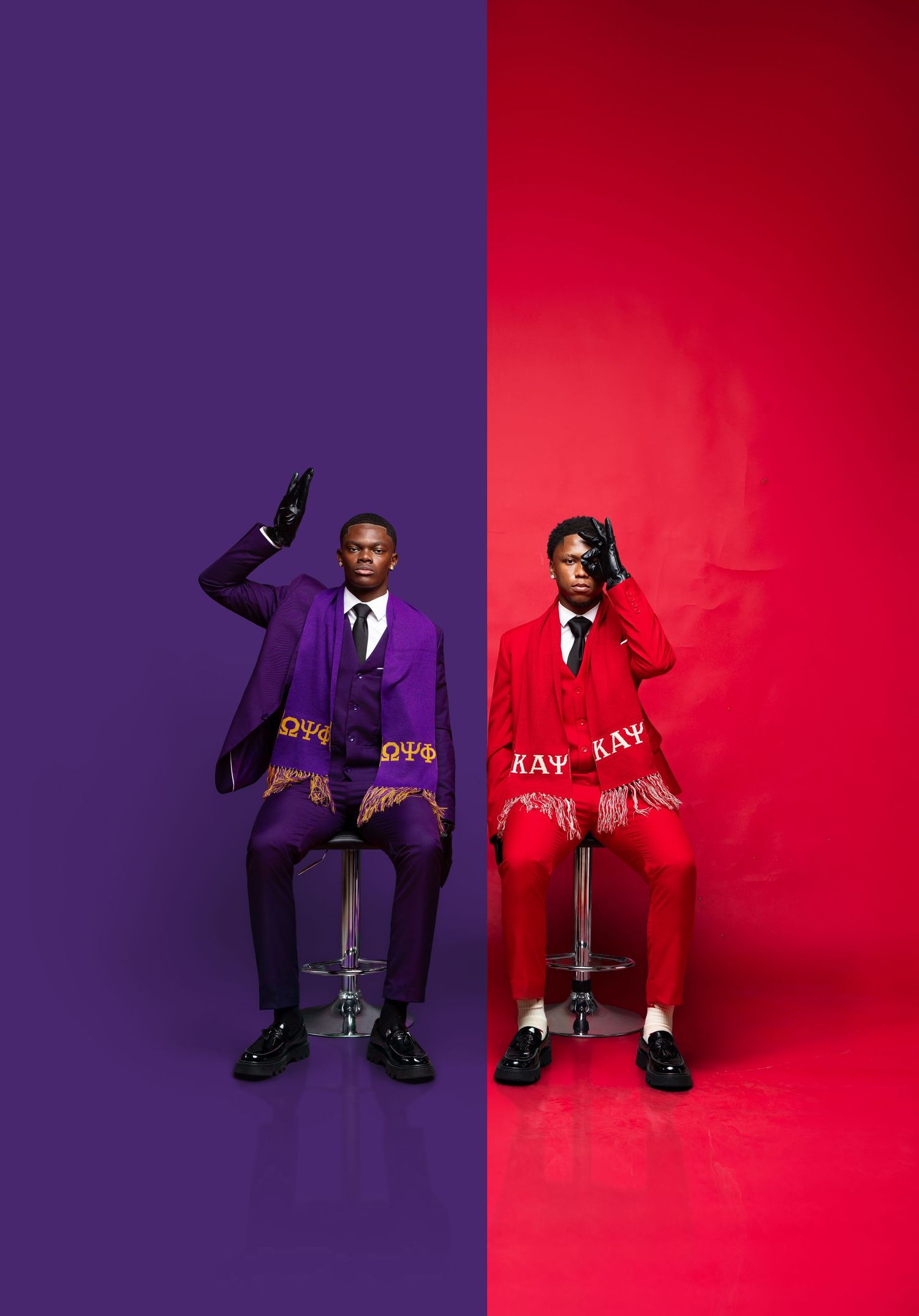 Two men in purple and red fraternity suits pose in a split-background photo studio setting. kappa and que dog brothers