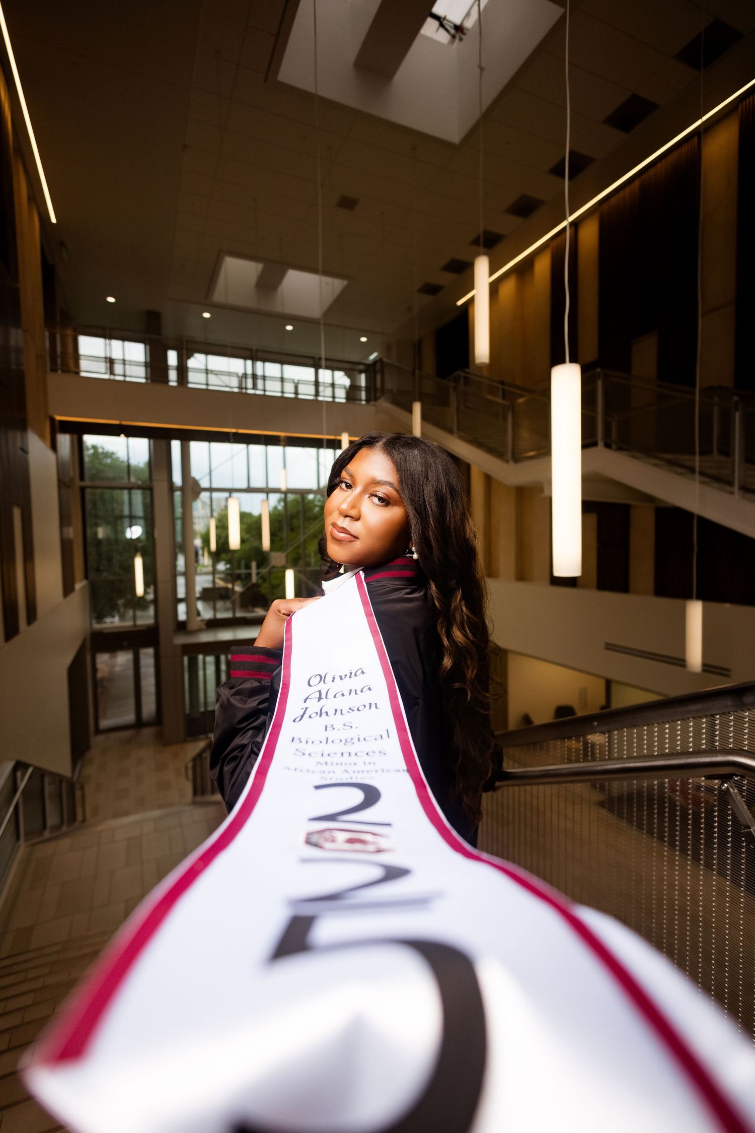 Creative graduation photo with angular interior architecture.