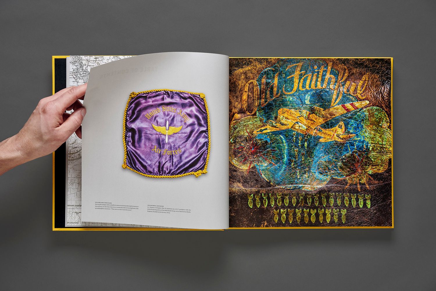 Hand holding open a Bomber Boys book spread with a purple satin jacket lining beside a colorful painted jacket reading Old Faithful.