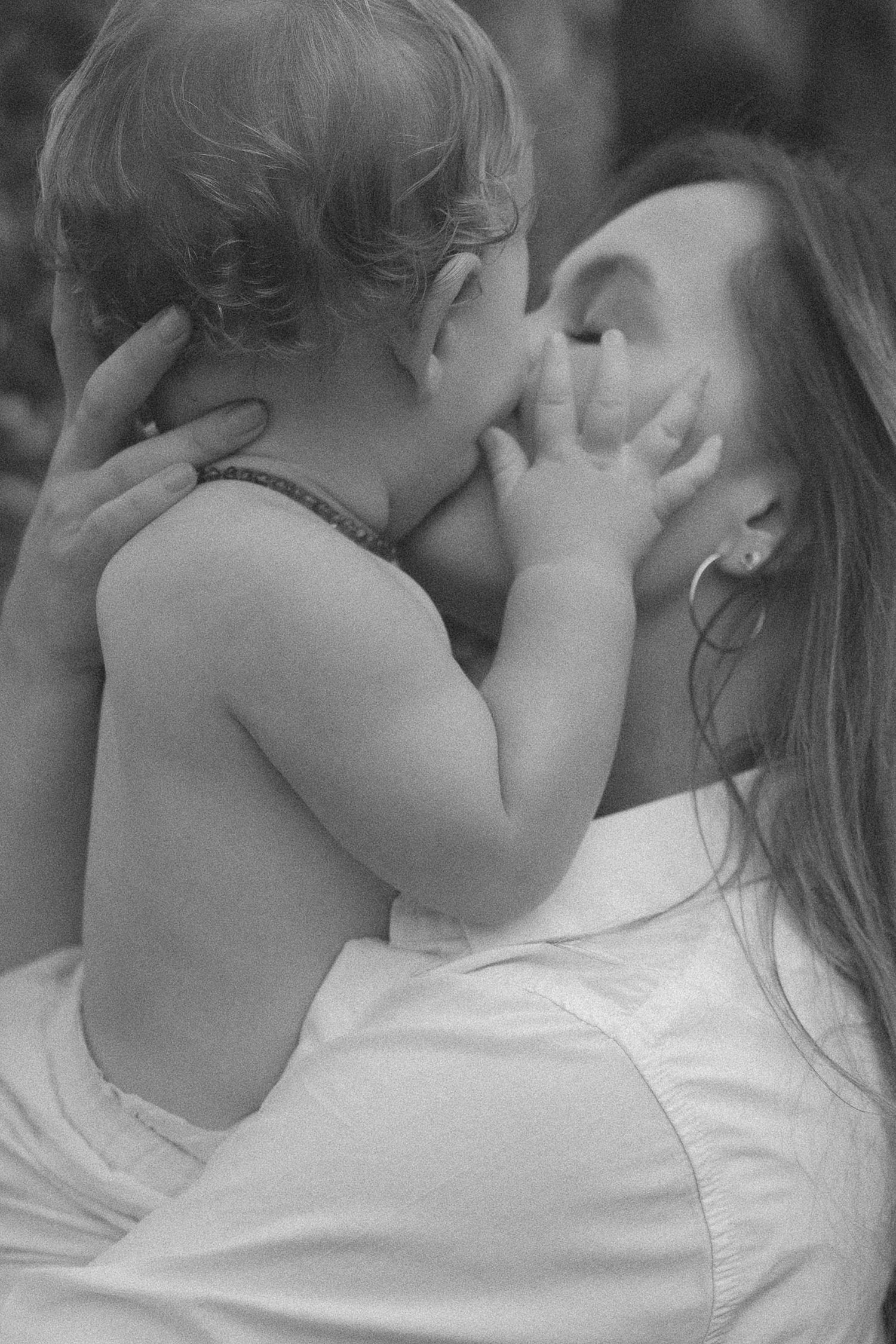 Black and white photo of mother holding baby in tender moment in New Zealand..