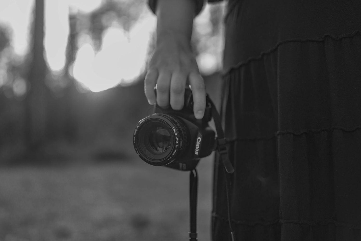 Gabbie Rose Photo, Spokane photographer holding Canon T6 camera at waistline with skirt tiers in view.