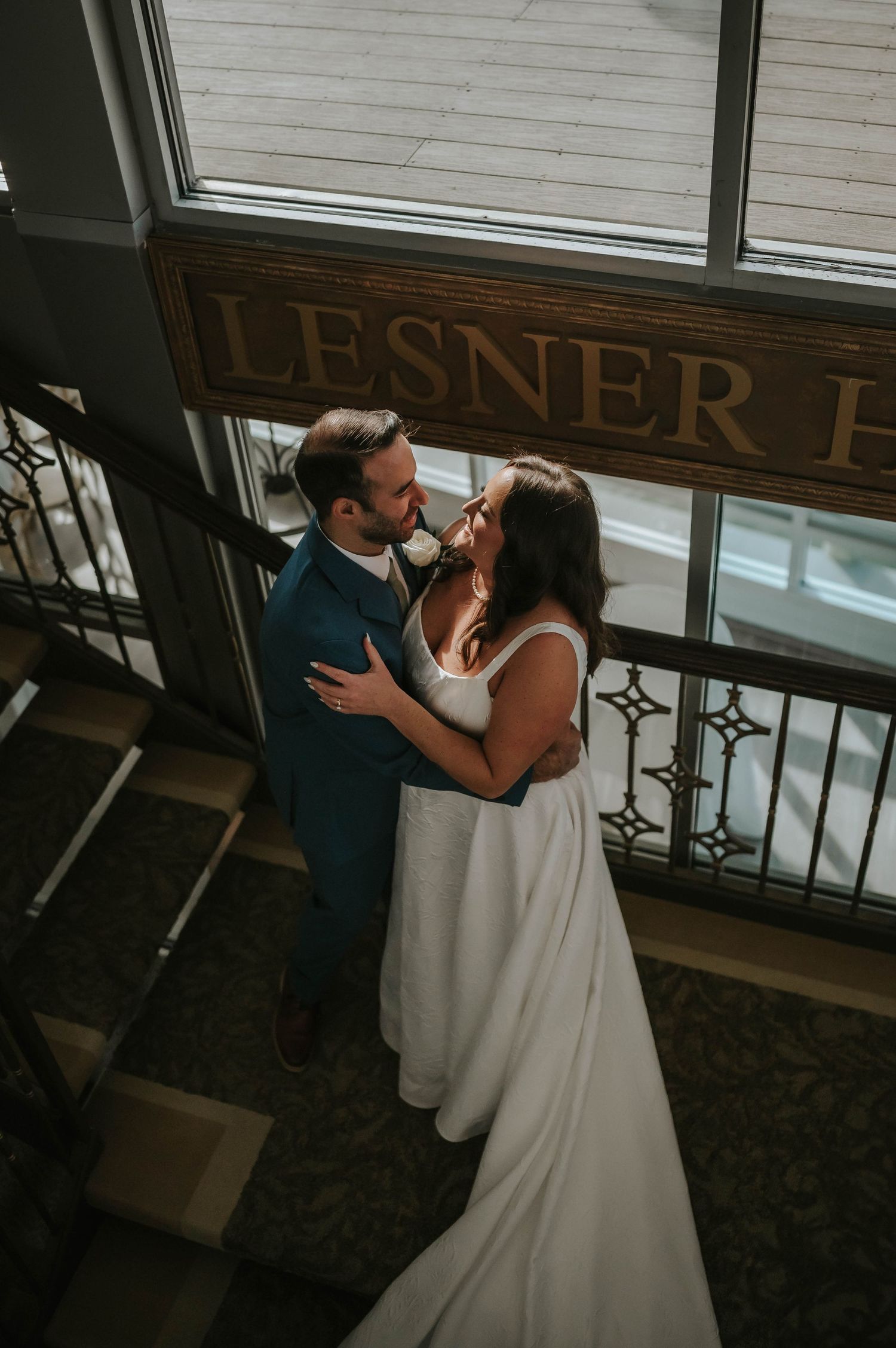 Wedding couple shares a romantic dance moment in an elegant indoor setting.