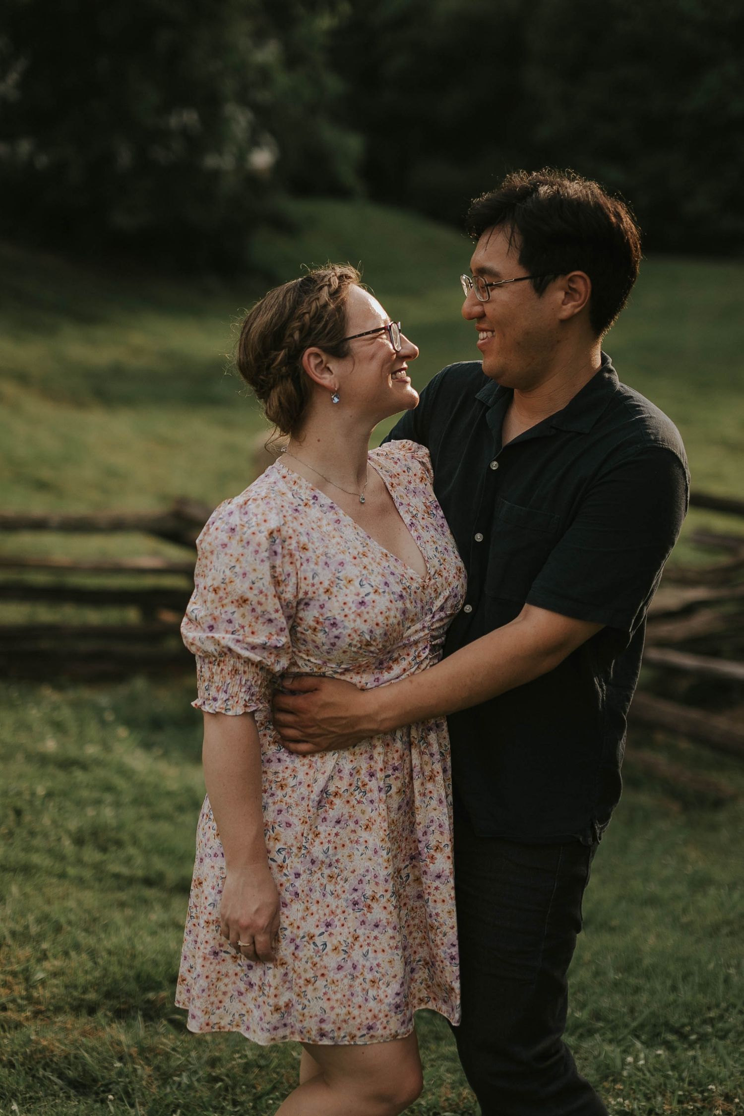 Romantic couple shares tender moments in a rustic outdoor setting during golden hour.