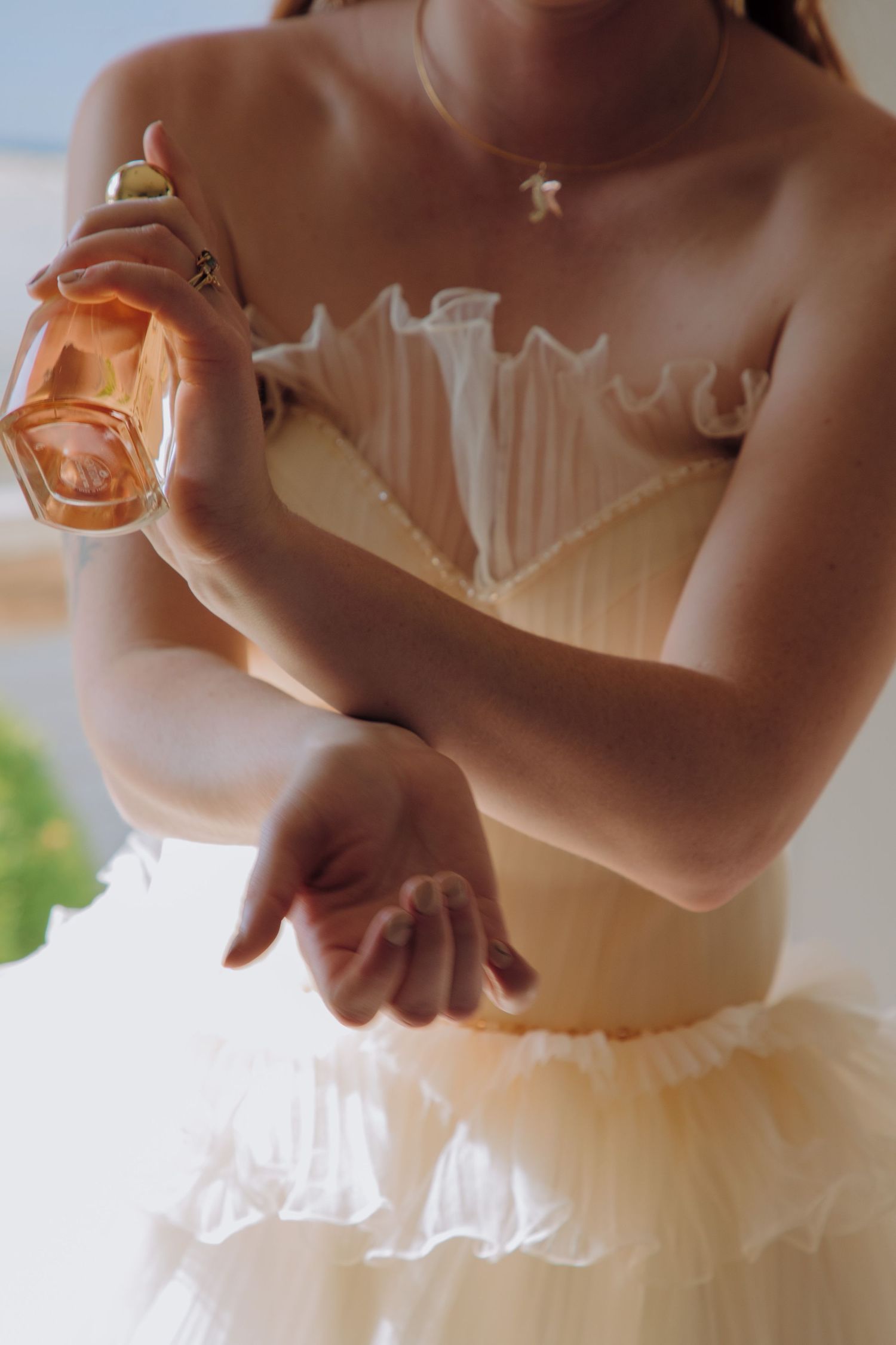 Close-up details of a white wedding dress bodice with delicate lace and ruffles.