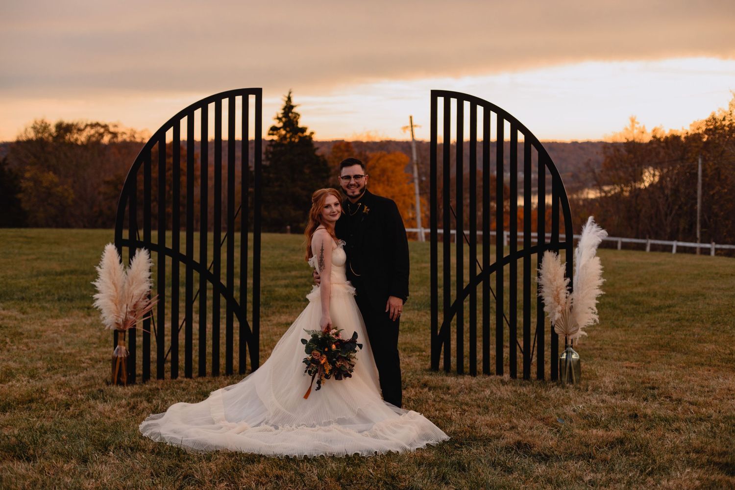 Sunset wedding photos through decorative metal garden gates.