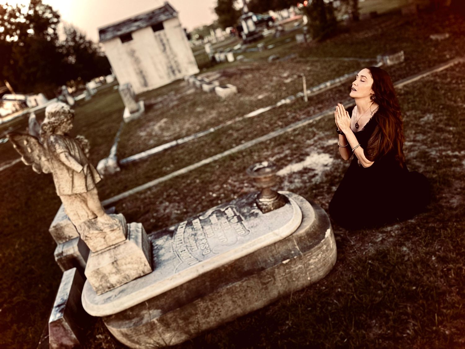 A series of vintage sepia photographs showing off beautiful woman sitting and posing on the ground in a cemetery